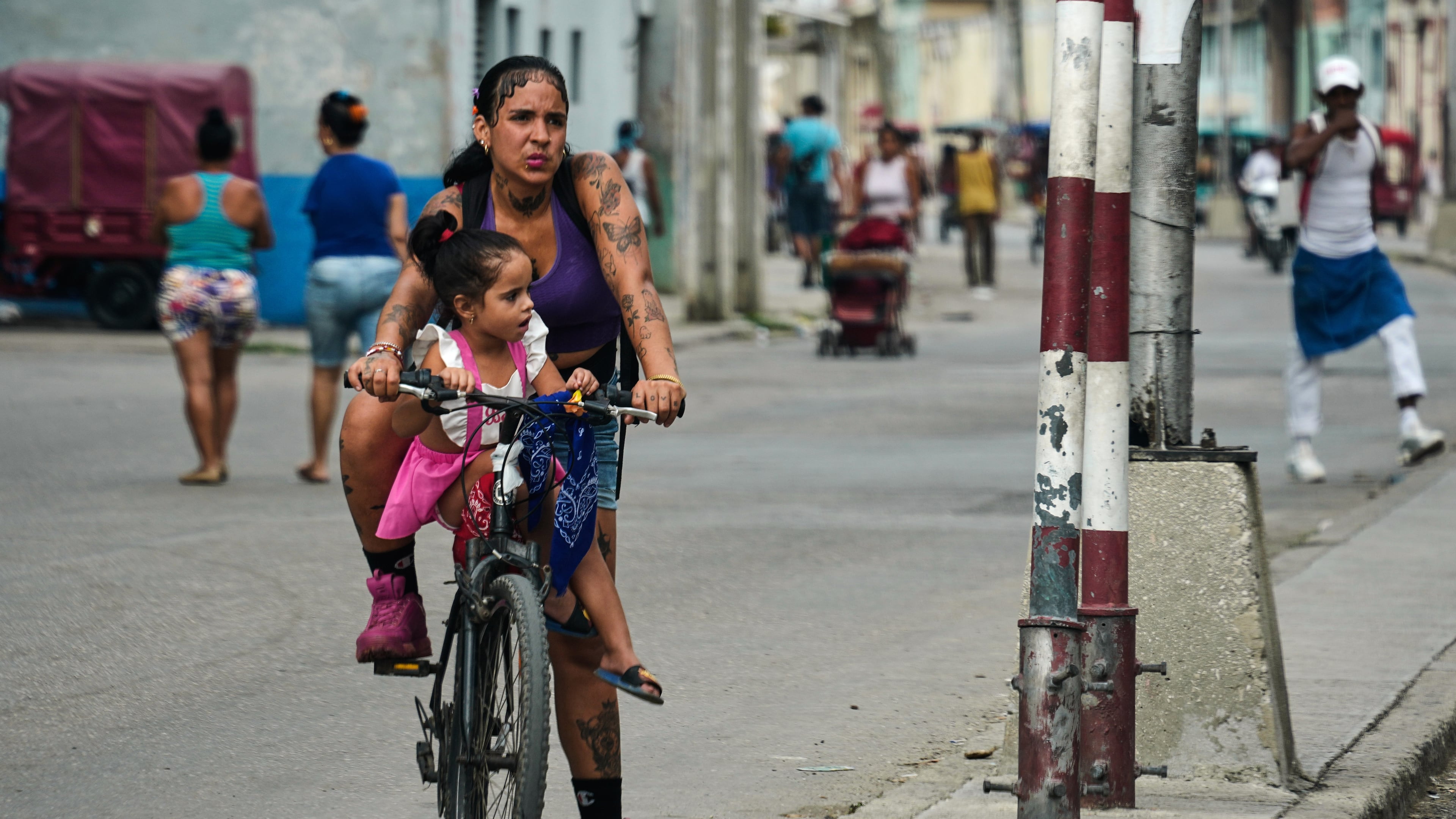 A woman carries a girl on a bicycle in Havana, Cuba, Friday, May 8, 2026. (AP Photo/Ramon Espinosa)