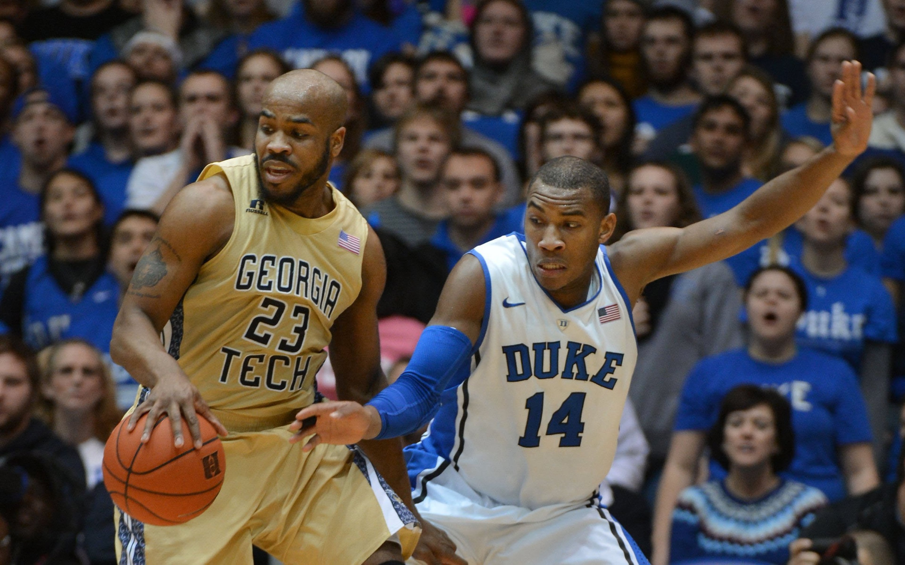 Duke Blue Devils guard Rasheed Sulaimon (14) looks to steal the ball from Georgia Tech Yellow Jackets guard Trae Golden (23) during the second half of play at Cameron Indoor Stadium in Durham, N.C., on Tuesday, Jan. 7, 2014. Duke beat Georgia Tech, 79-57.