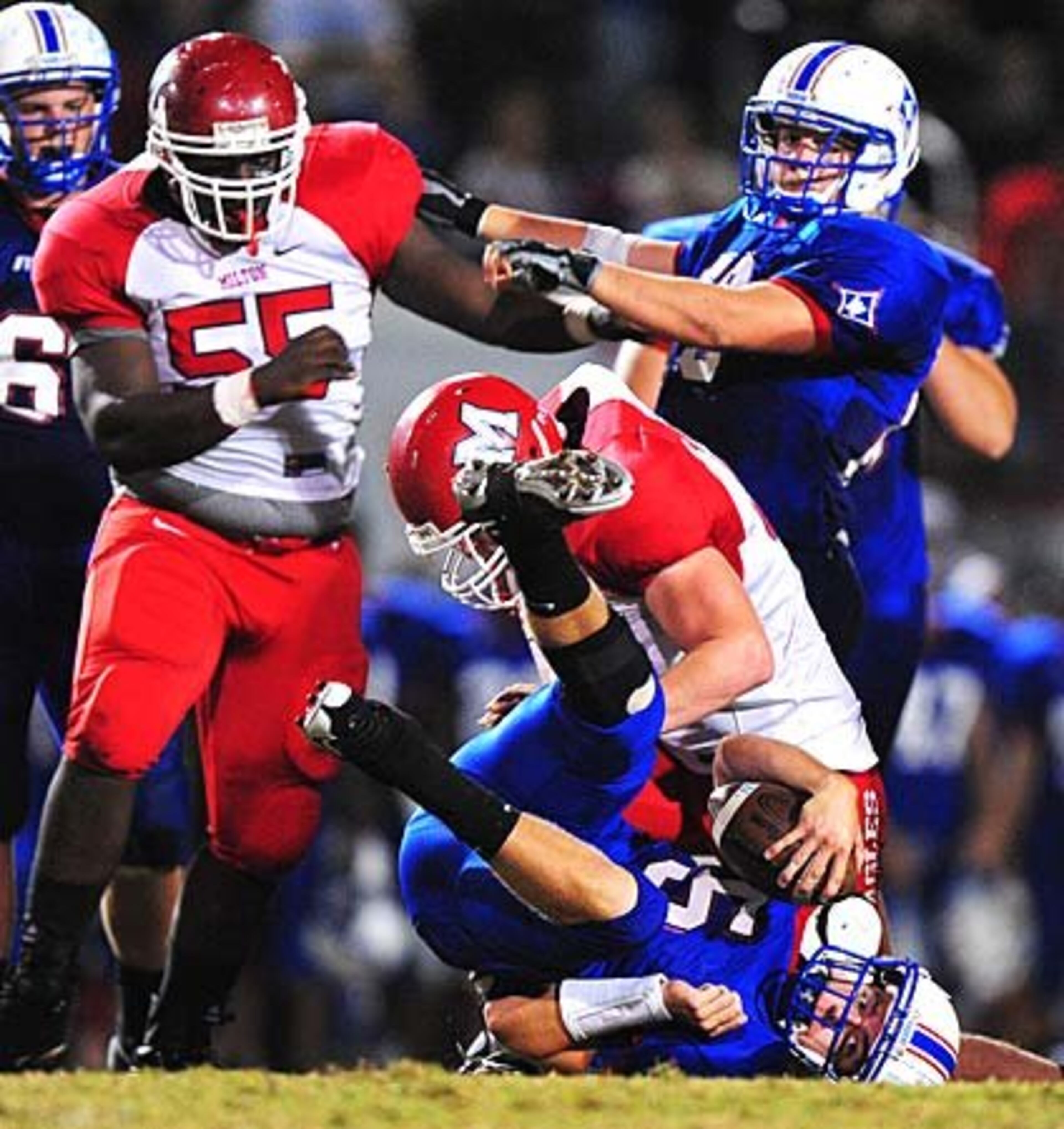 Milton's Andrew Quinlan (60) sacks Walton Raiders quarterback Ray Rayburn (5) during the second quarter.