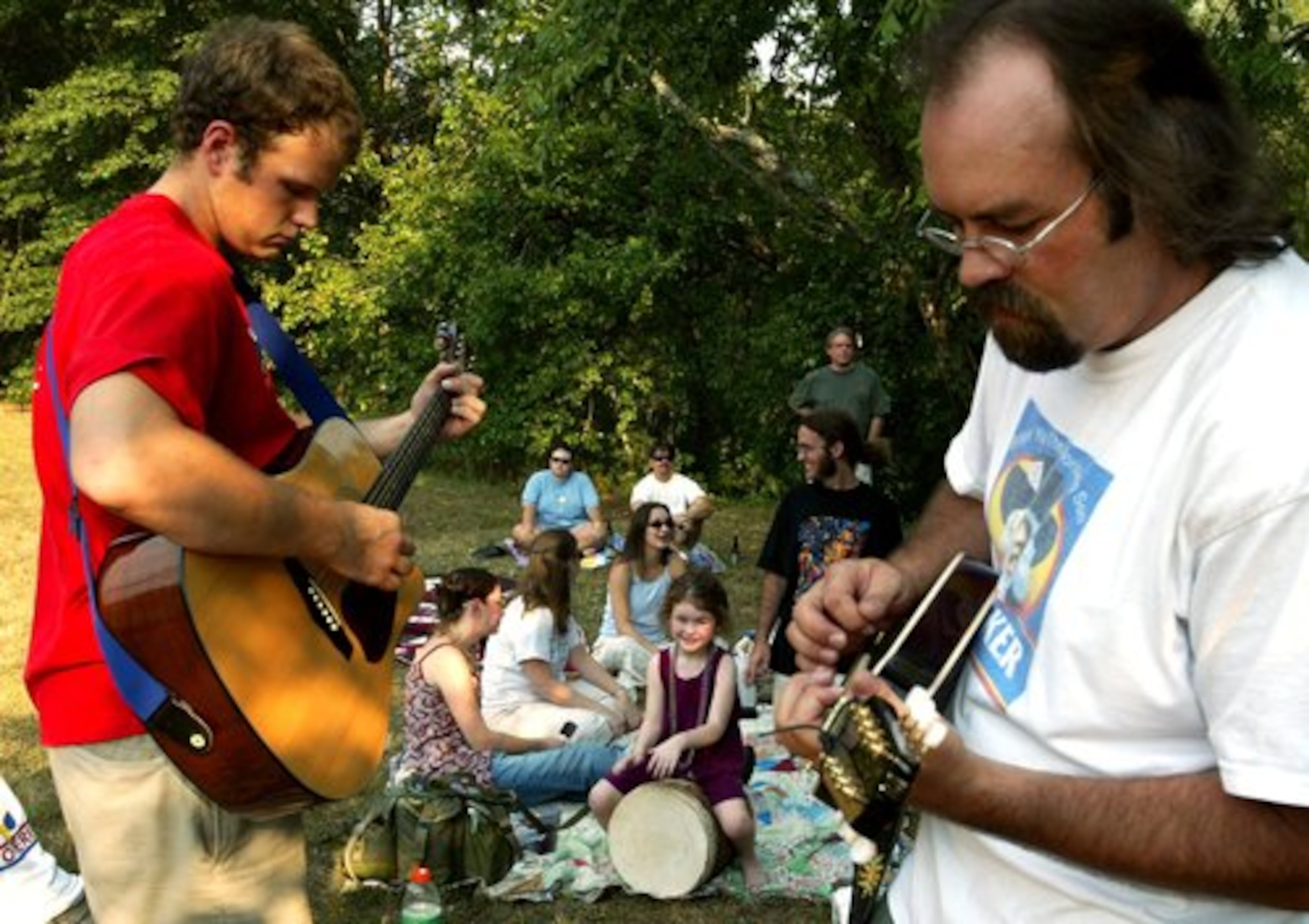 2002: (l-r) Patrick Kunes on guitar, Cassidy Ingram, 5 (drums) & Tom Scarborough (mandolin) play for a small group of devoted Widespread Panic fans at a memorial for guitarist Michael Houser at Dudley Park in Athens.