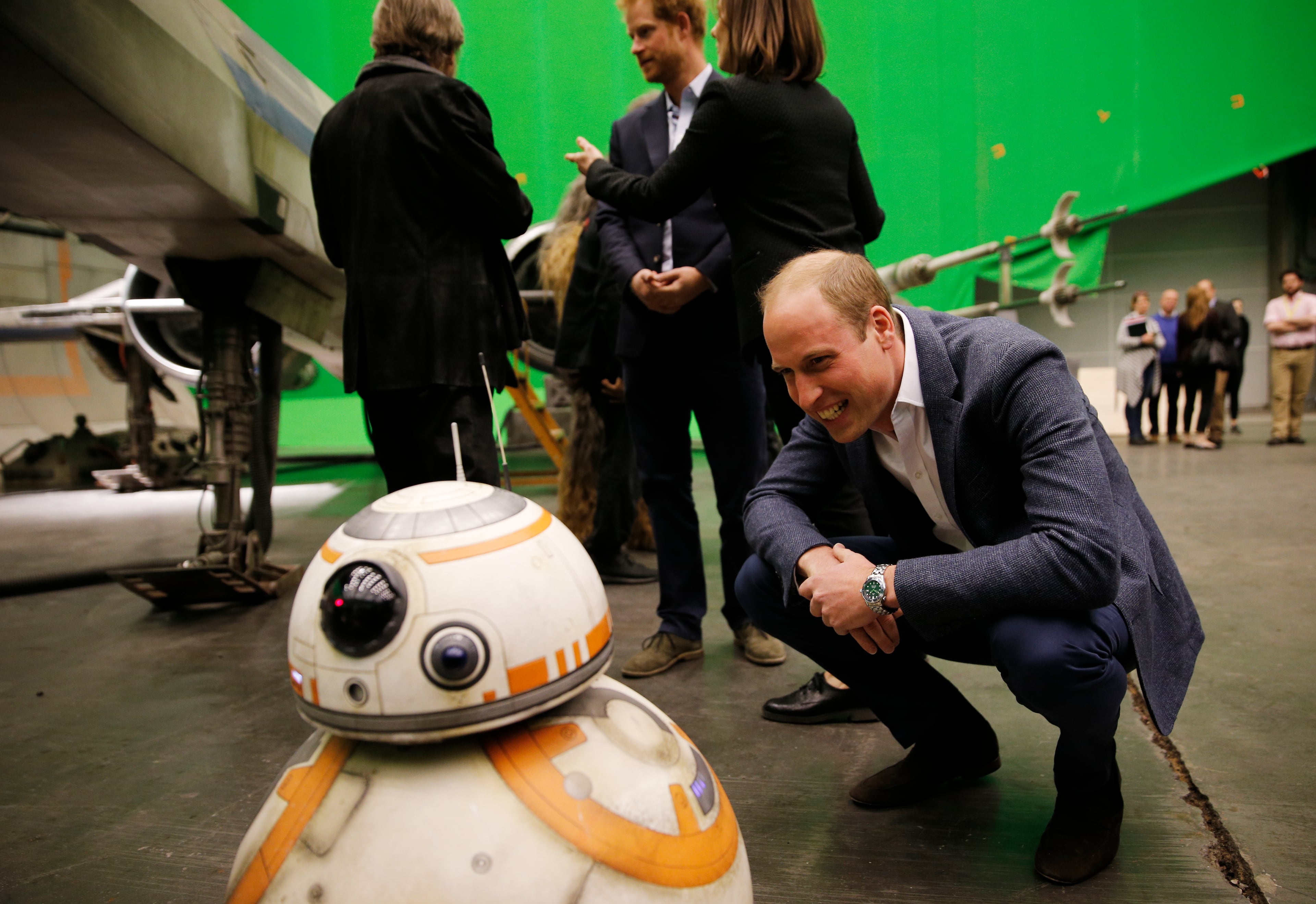 IVER HEATH, ENGLAND - APRIL 19: Prince William, Duke of Cambridge smiles at the BB-8 droid during a tour of the Star Wars sets at Pinewood studios on April 19, 2016 in Iver Heath, England. Prince William and Prince Harry are touring Pinewood studios to visit the production workshops and meet the creative teams working behind the scenes on the Star Wars films. (Photo by Adrian Dennis-WPA Pool/Getty IMages)