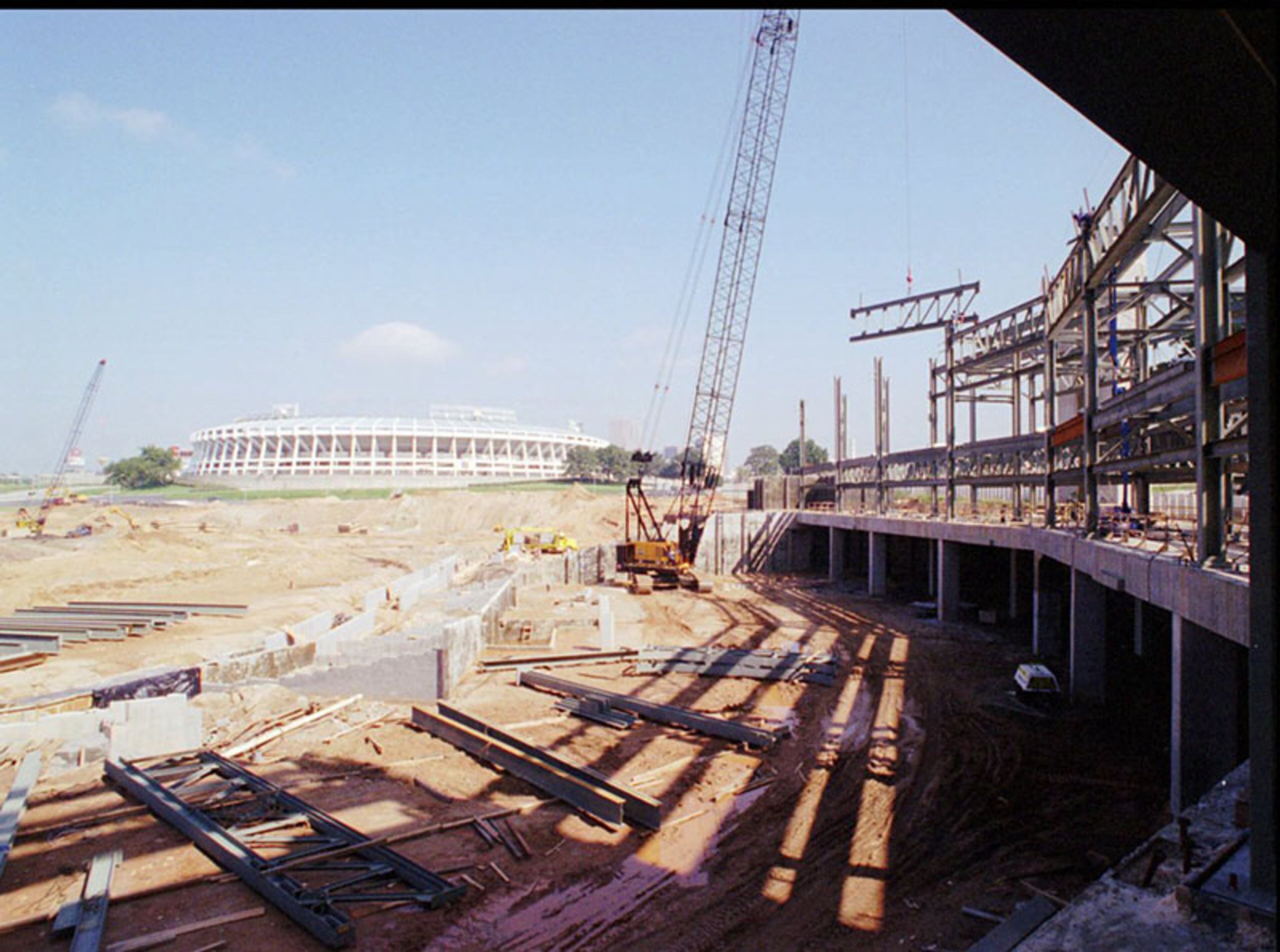 A construction crane lifts steel beams into place as the superstructure for the stands at the centennial Olympic Stadium in Atlanta begin to take shape at the centerpiece for the 1996 Olympic Games in 1994. The facility, whihc seats will seat more than 45,000 was built in the parking lot of Fulton County Stadium (background) and would replace that stadium as the home of the Braves.