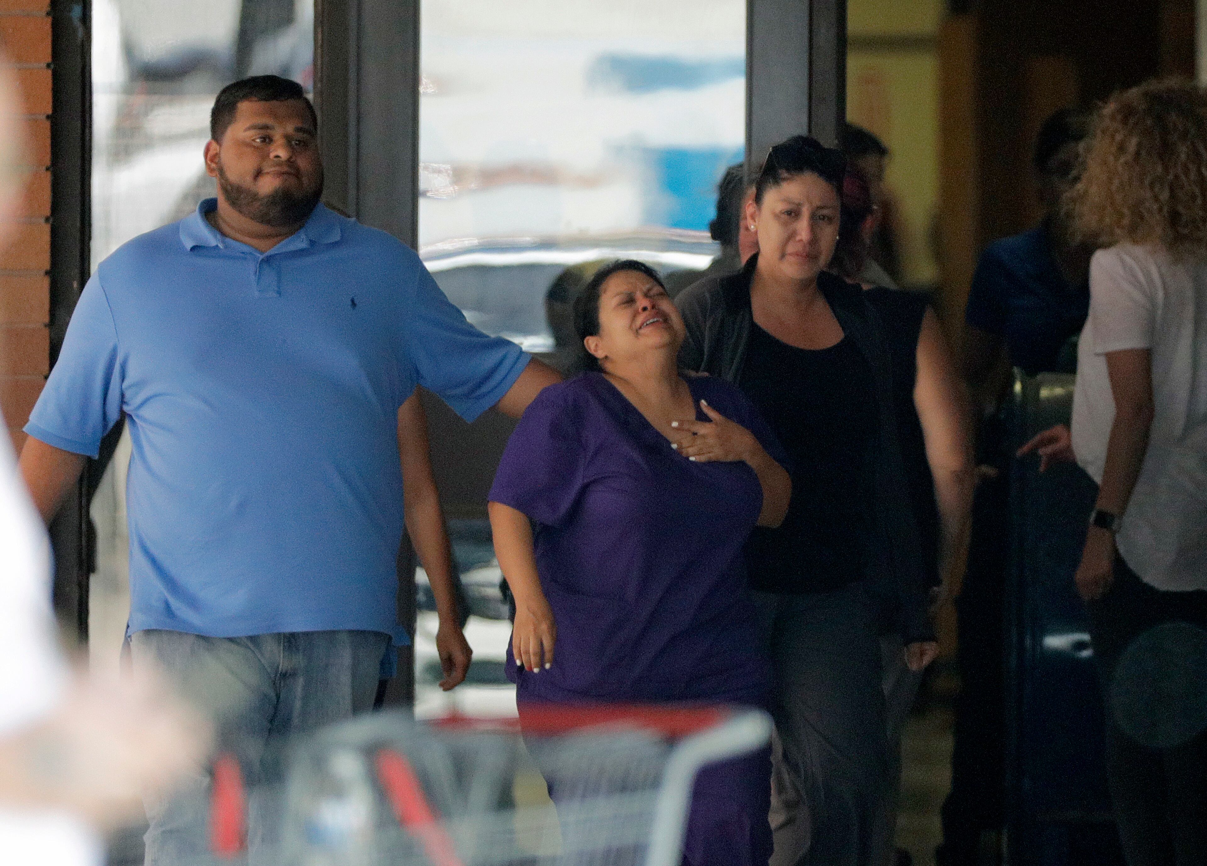 People react as they leave the family unification center at the Alamo Gym, following a shooting at Santa Fe High School Friday, May 18, 2018, in Santa Fe, Texas. (AP Photo/David J. Phillip)