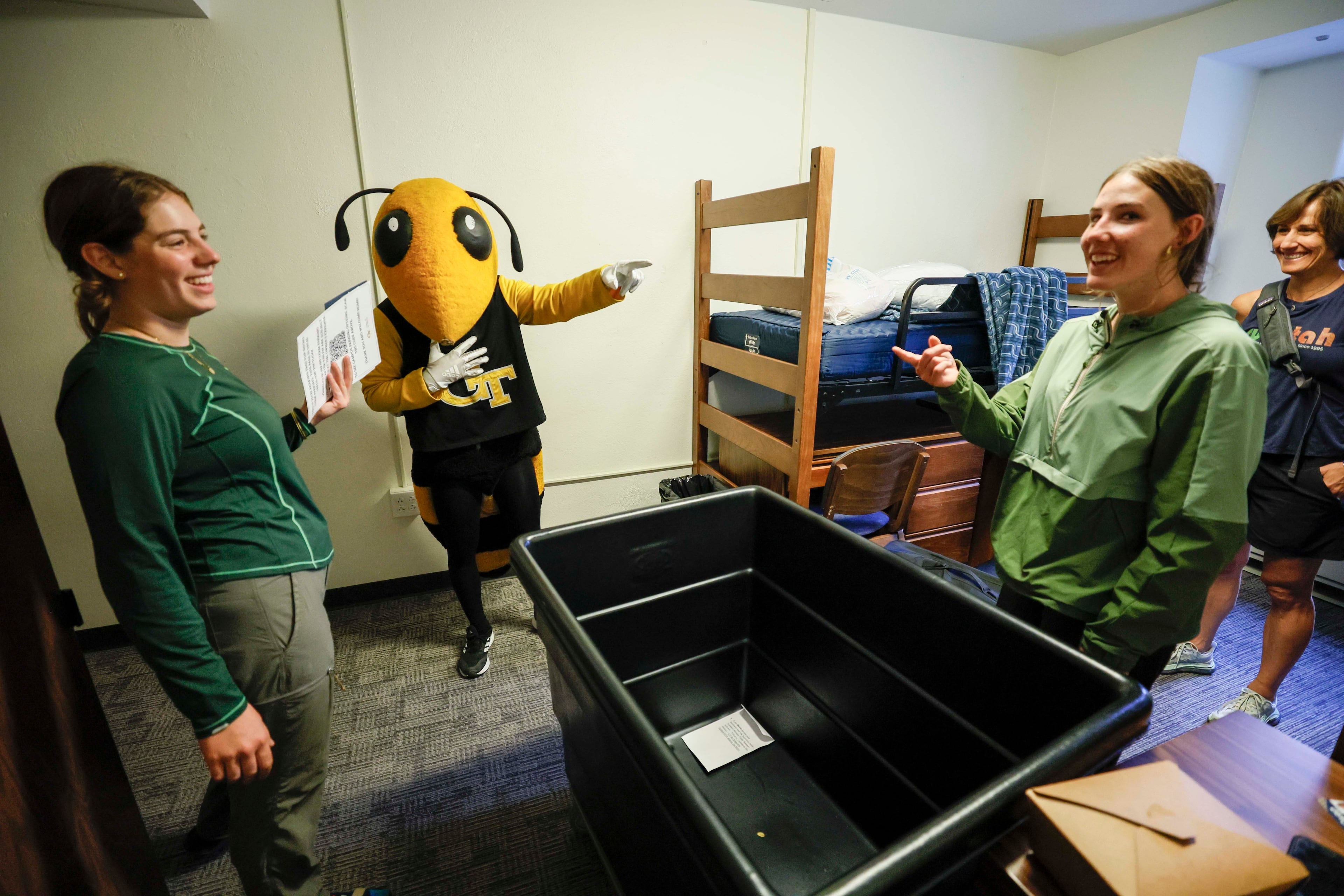 Georgia Tech mascot Yellow Jacket Buzz teases civil and environmental student Sofia Jouraron and mechanical engineering student Olivia Cozette during move-in day at Georgia Tech.
(Miguel Martinez/AJC 2025)