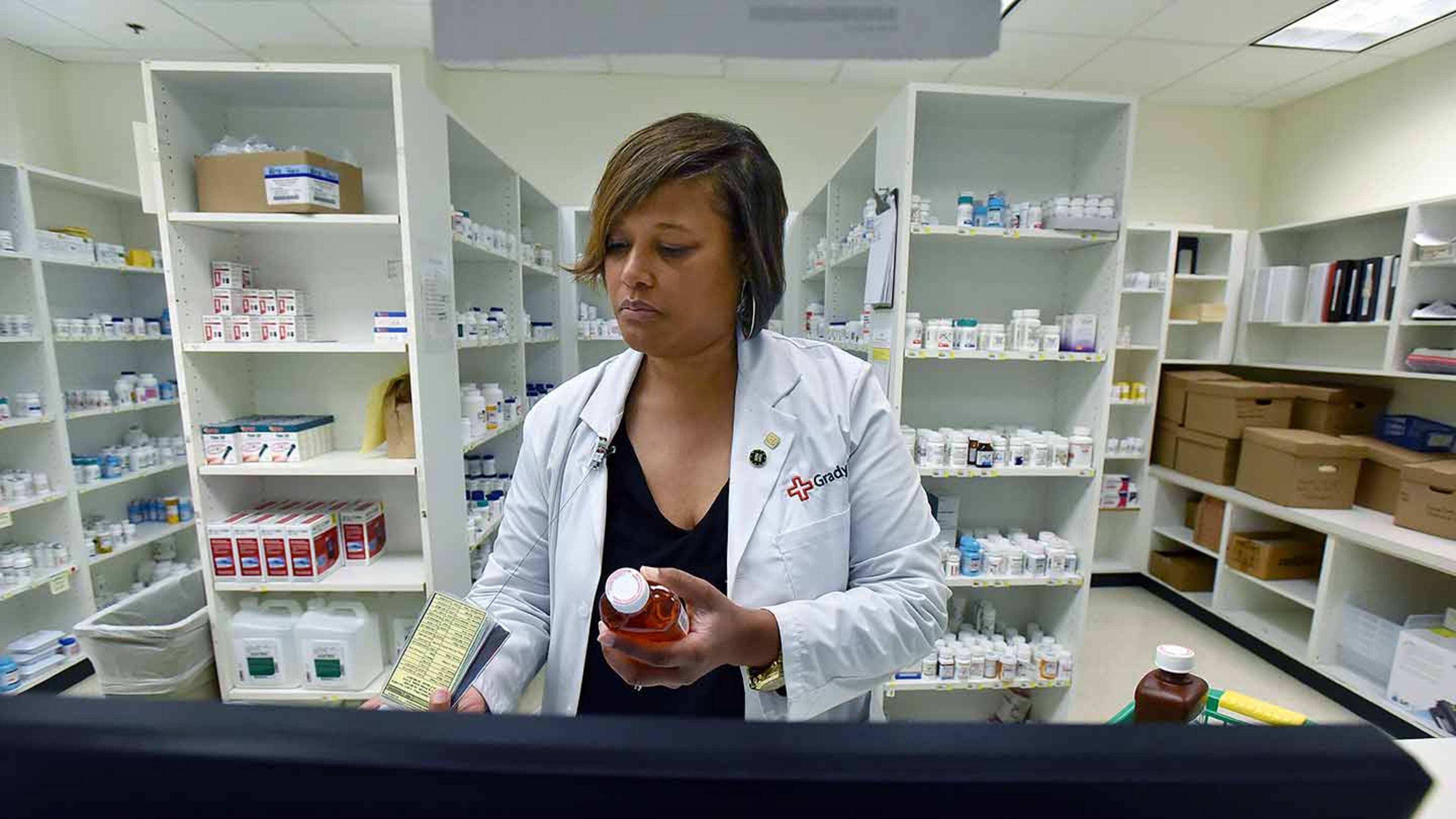 Pharmacist Bridget McCord prepares prescriptions at Grady Memorial Hospital. It provides prescriptions for $5 or less to thousands of outpatients who are low-income or do not have insurance.