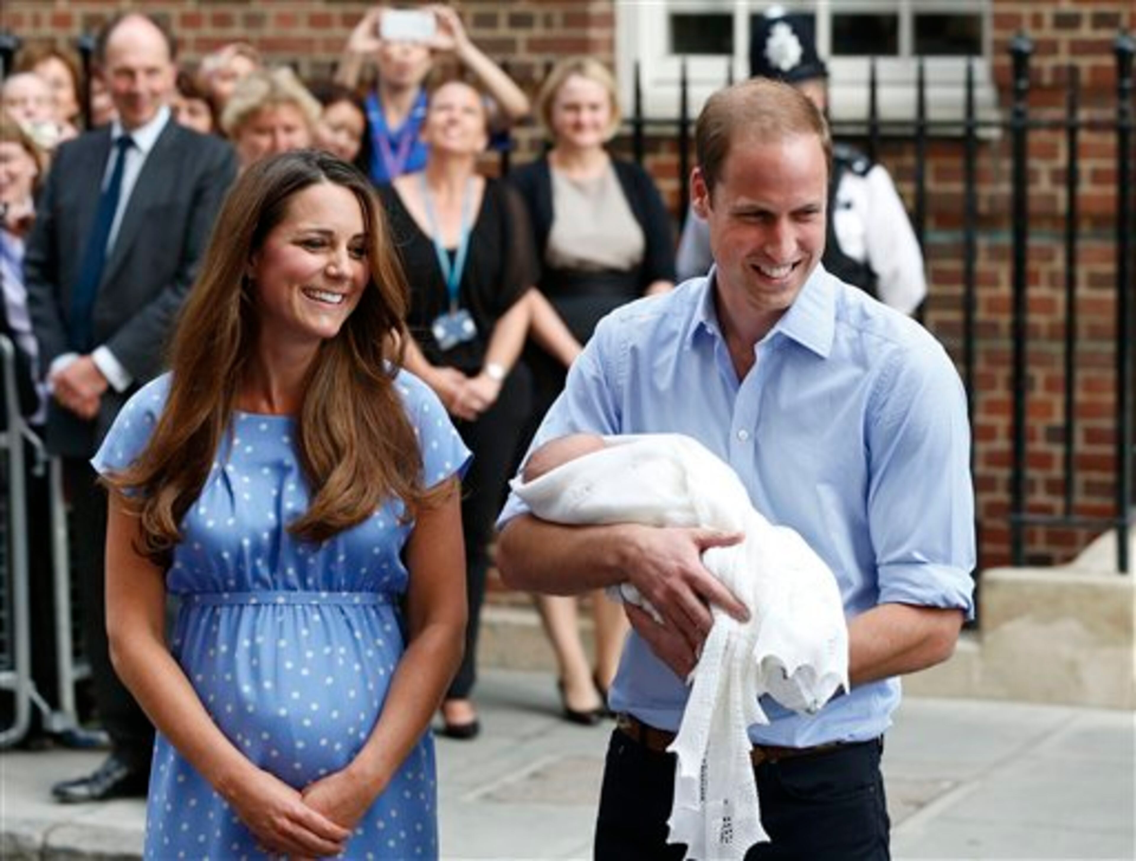 Britain's Prince William and Kate, Duchess of Cambridge hold the Prince of Cambridge, Tuesday July 23, 2013, as they pose for photographers outside St. Mary's Hospital exclusive Lindo Wing in London where the Duchess gave birth on Monday July 22. The Royal couple are expected to head to London�s Kensington Palace from the hospital with their newly born son, the third in line to the British throne. (AP Photo/Lefteris Pitarakis)