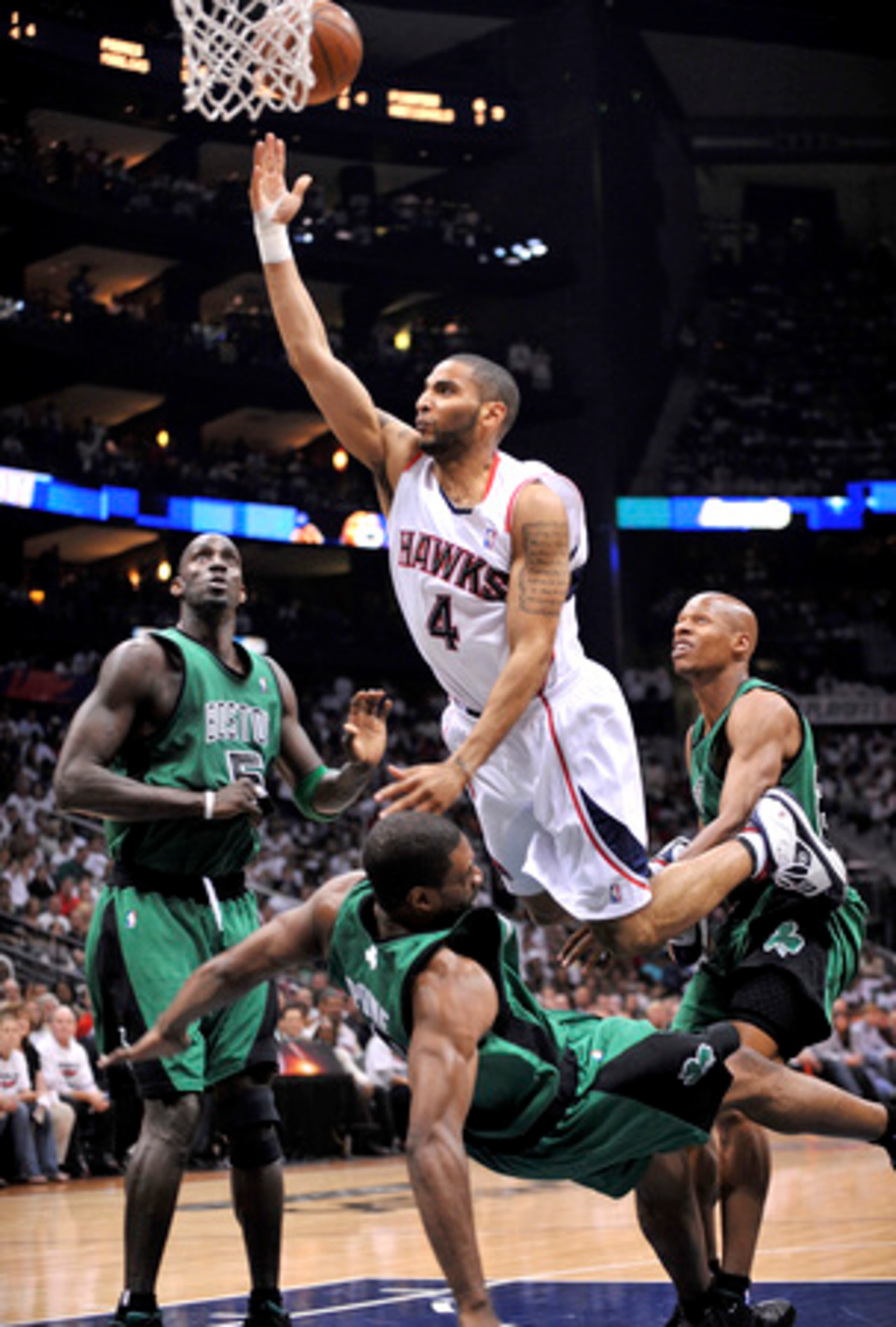 Hawks guard Acie Law IV (2 points, 2 assists) drives into Celtics forward Leon Powe on his way to the rim.