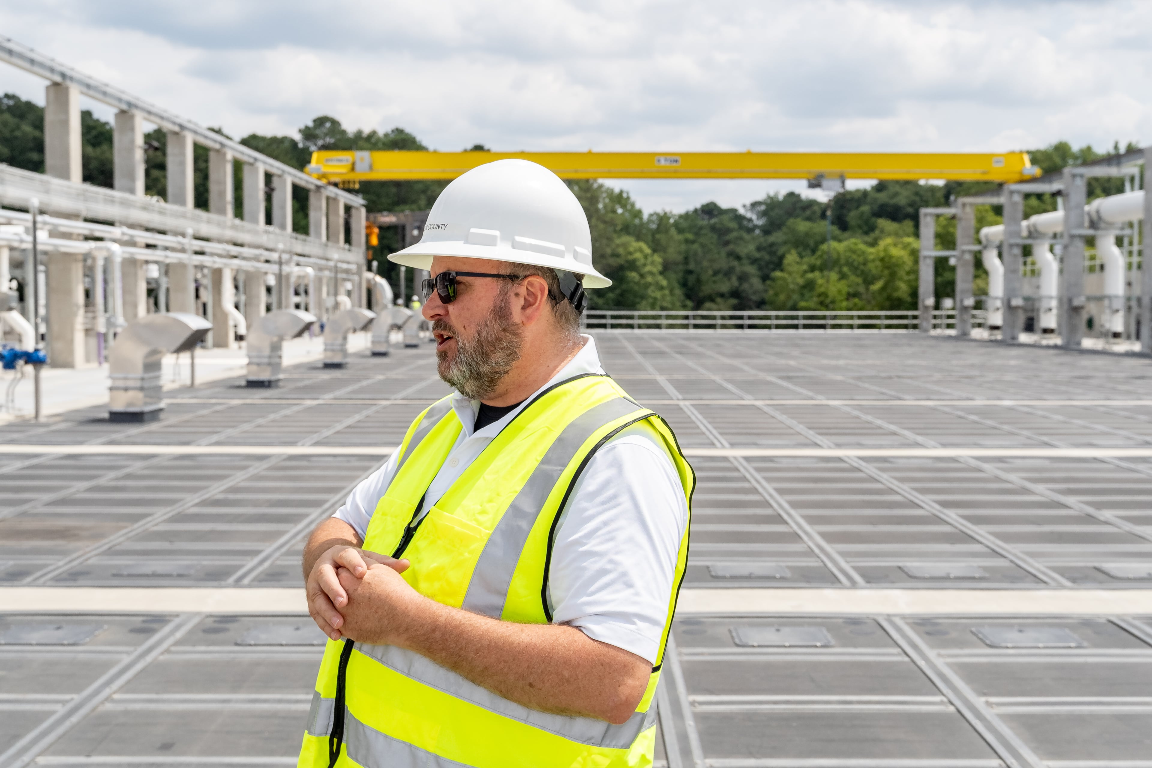 Fulton County Director of Public Works David Clark stands above one of the many new treatment membrane tanks at the new water reclamation facility built on the grounds of the existing Big Creek Wastewater Treament Center. (Ben Hendren for the AJC 2024)