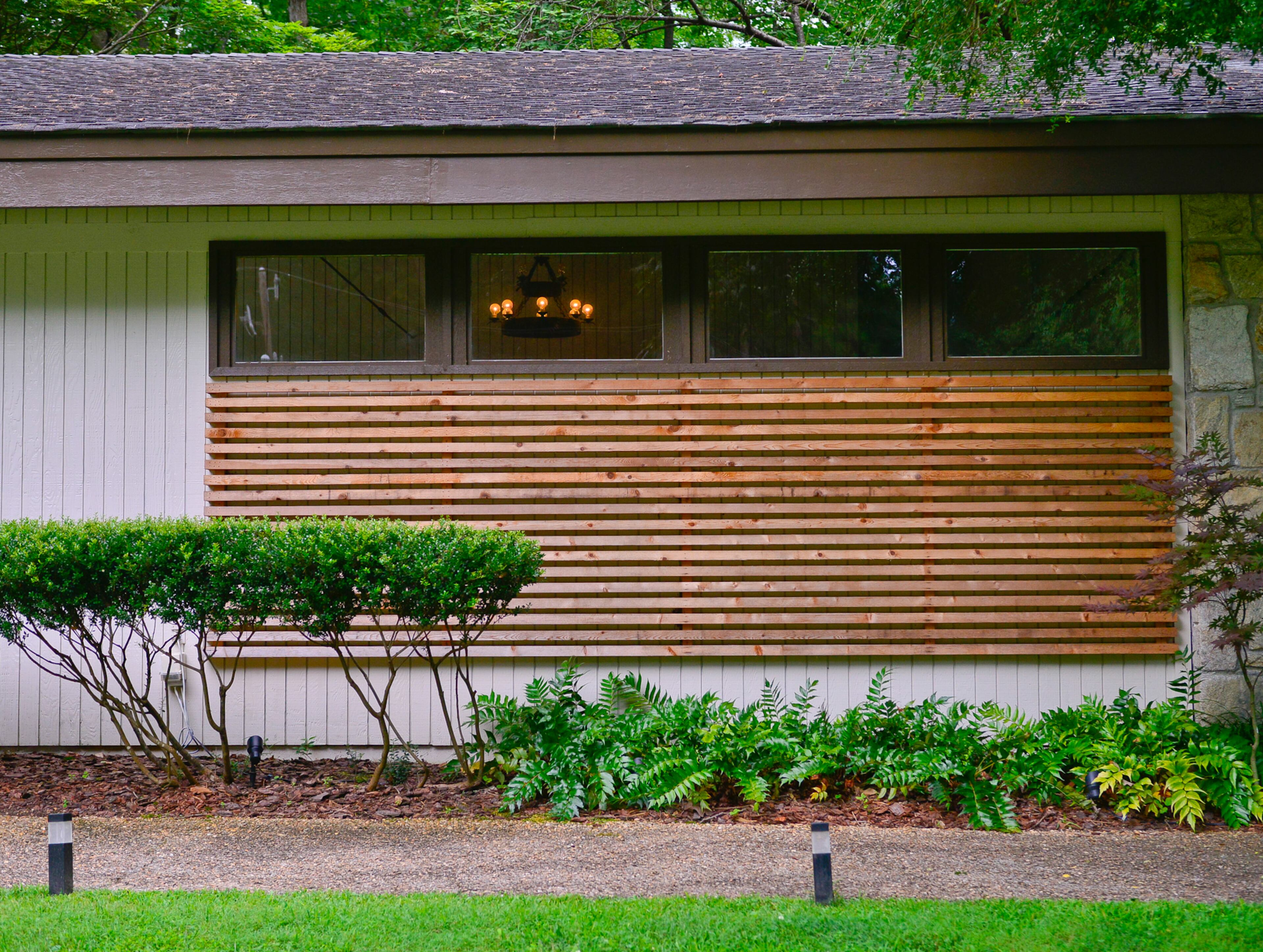 Homeowner James Smith designed the wood slat trim used to update the home but retain its mid-century modern aesthetic. To improve the curb appeal, the exterior also was painted a lighter color.