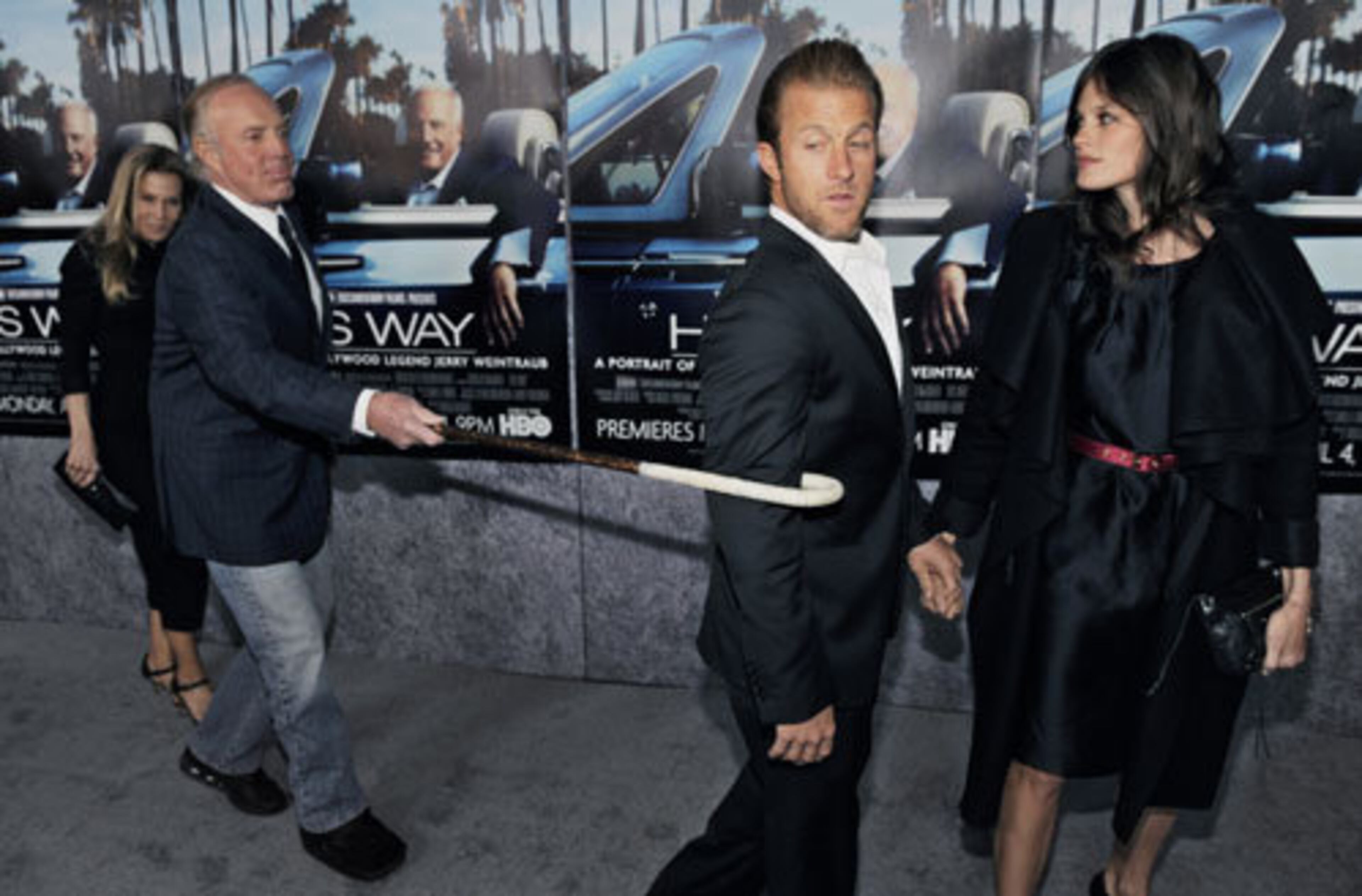 Actor James Caan, left, pulls in his son, actor Scott Caan, with a cane.