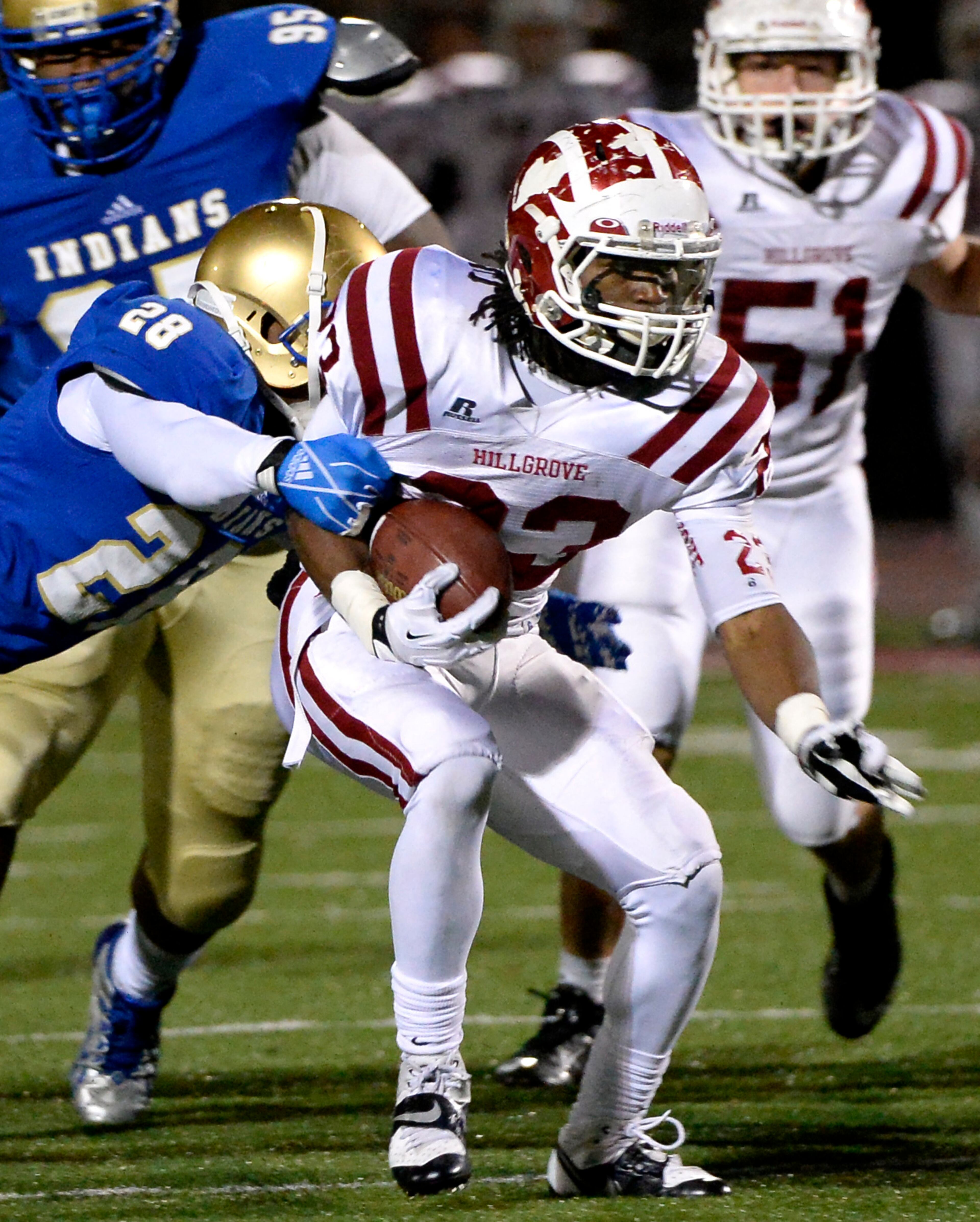Hillgrove's Richardre Bagley (23) gets past McEachern's Fitz Wattley (28) for a first down in the first half of their high school football game at Cobb Energy Field on Friday, Nov. 8, 2013, in Powder Springs, Ga.