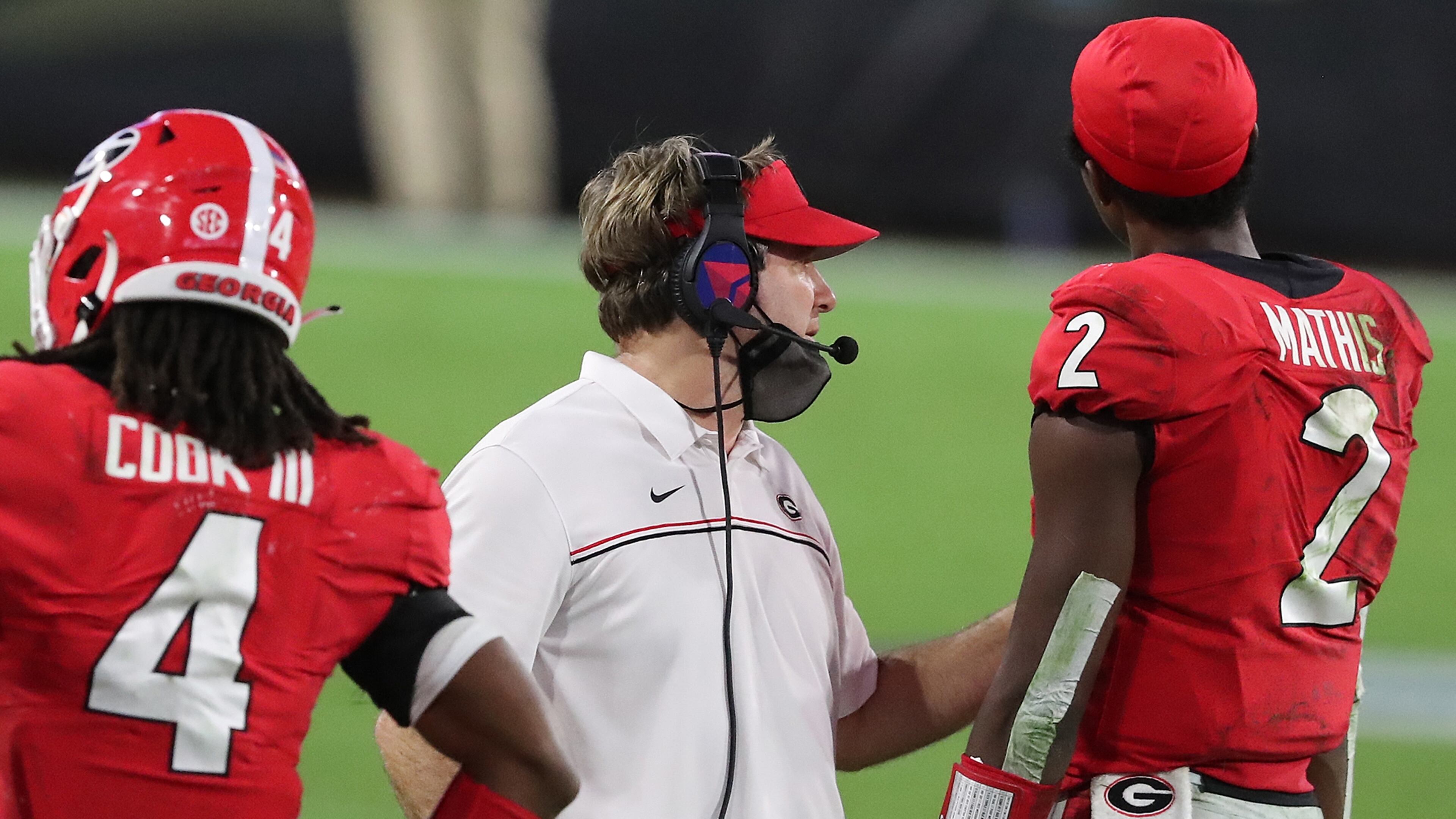 Georgia coach Kirby Smart on the field with D’Wan Mathis and James Cook in the final minutes of the game against the Florida Gators Saturday, Nov. 7, 2020, in Jacksonville, Fla.
