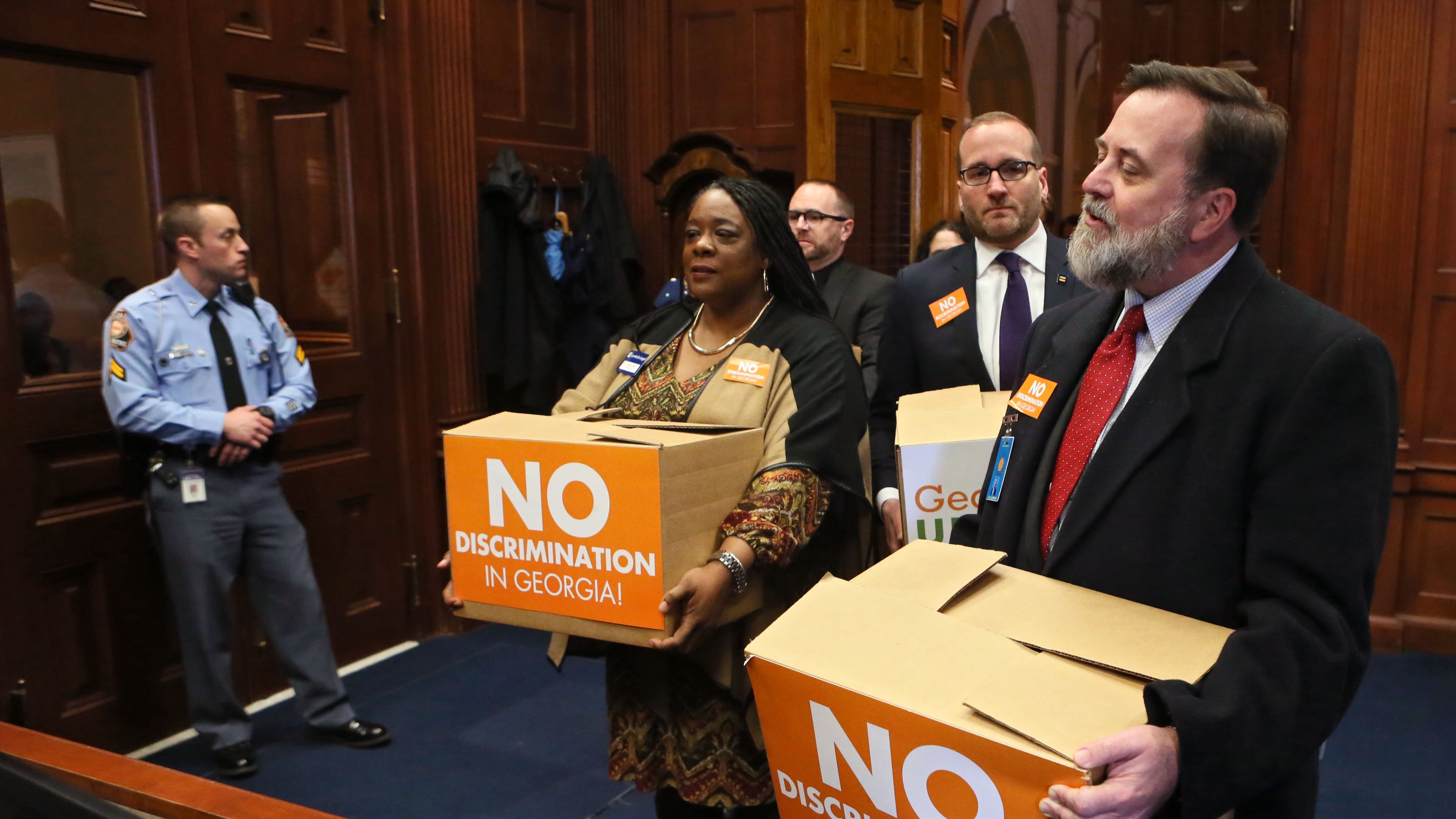 Jeff Graham (right) executive director of Georgia Equality, leads supporters carrying boxes of postcards into then-Gov. Nathan Deal’s office on March 2, 2016. Representatives from gay rights groups delivered copies of 75,000 emails to state leaders urging them to defeat so-called religious liberty legislation they believed would legalize discrimination. (Bob Andres/AJC)