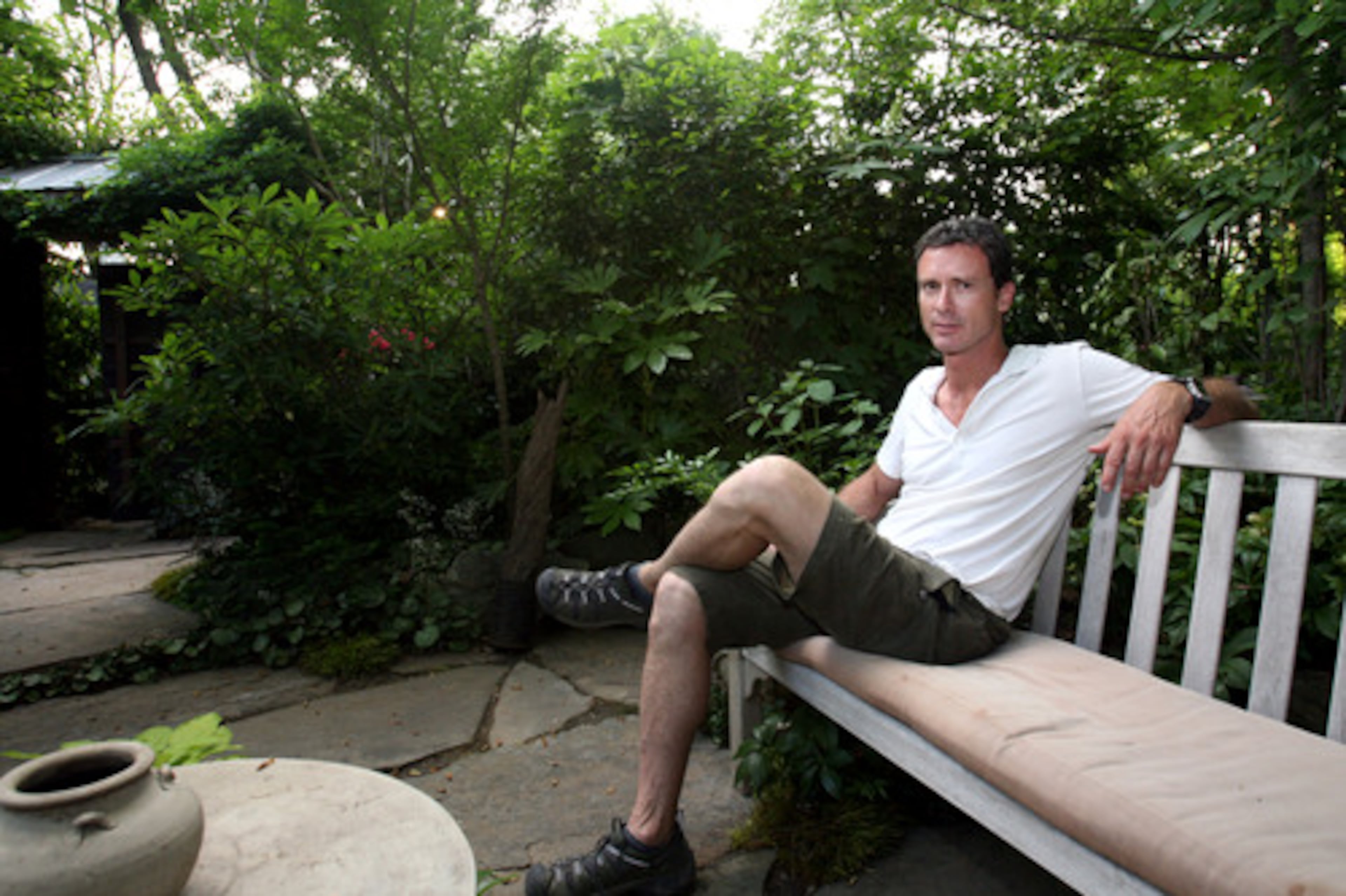 Ellis said his backyard garden was designed around this seating area. When he first moved into the house, he placed three lawn chairs in this spot because of the way the afternoon sun lit the area. "This became the center of everything I wanted to do," he explained. From there, he created privacy by planting trees and shrubs along the border of his property. Next, he planted trees and built pathways within the garden itself.