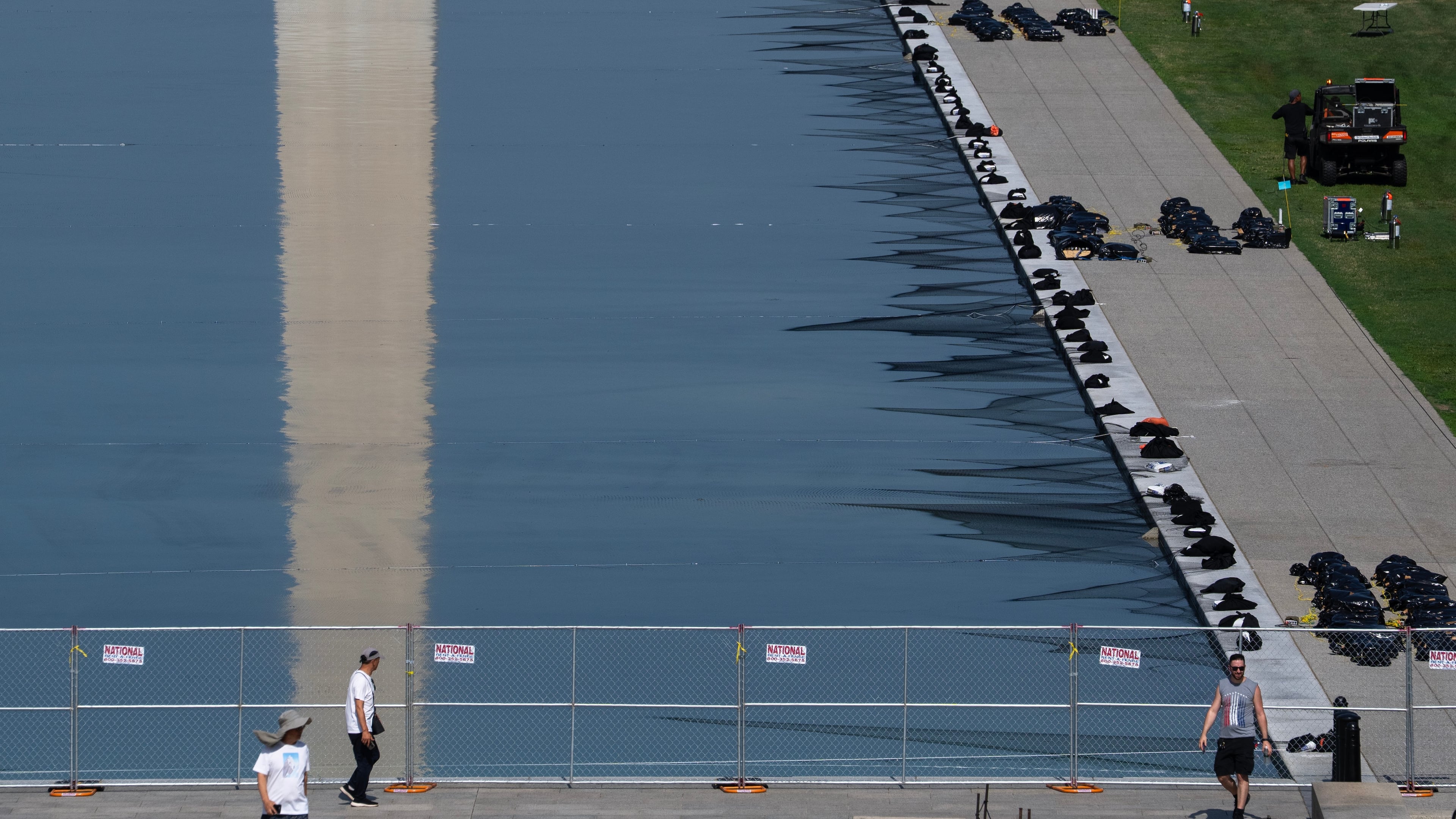 Workers install fireworks along the edge of the Lincoln Memorial Reflecting Pool ahead of the America 250 July 4th celebration on the National Mall, Thursday, July 2, 2026, in Washington. (AP Photo/Nathan Howard)