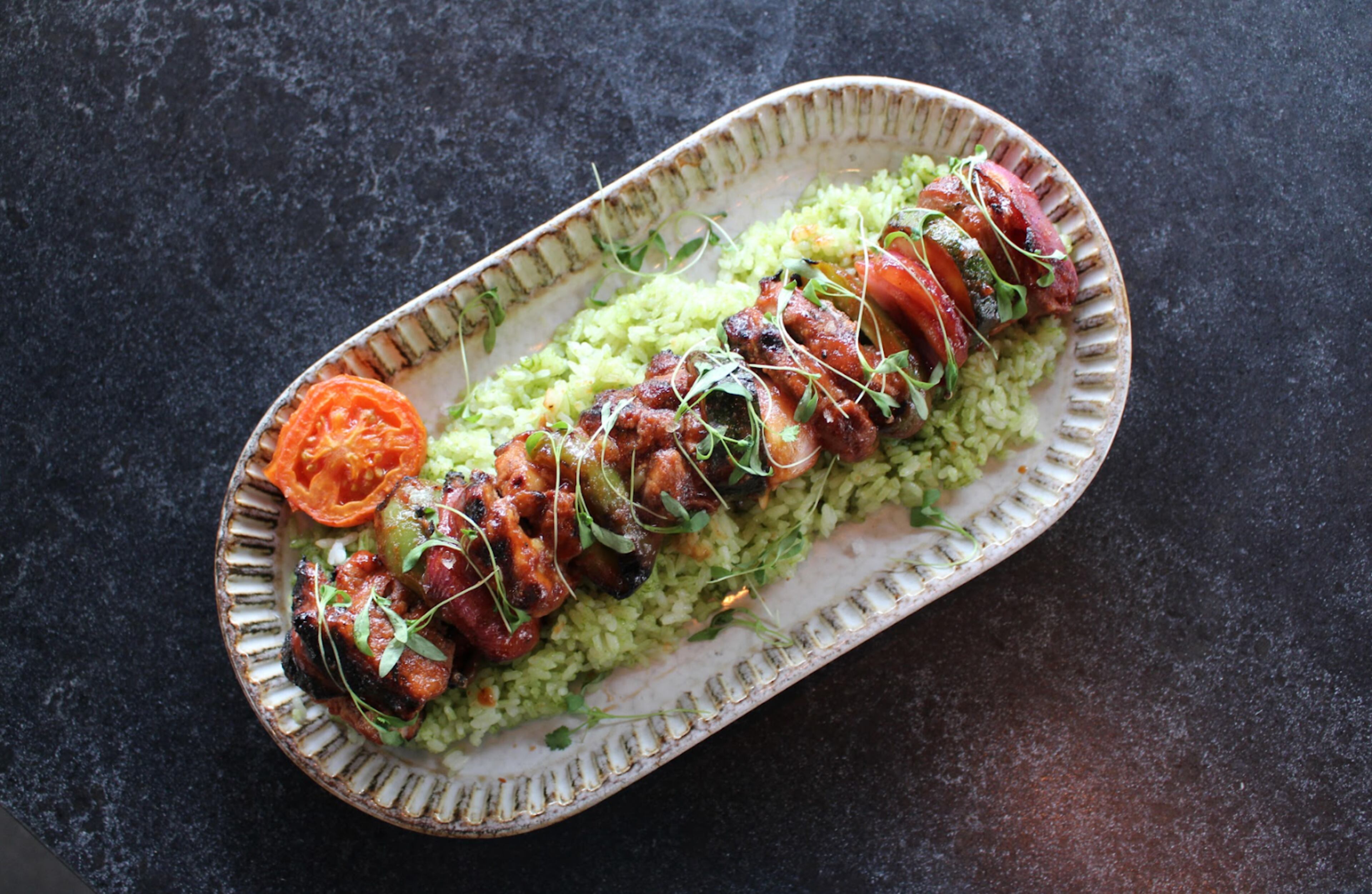 Fogón and Lion's fall menu includes the Iberian pork skewer with cilantro rice and Filipino barbecue sauce. (Courtesy of Fogón and Lions)