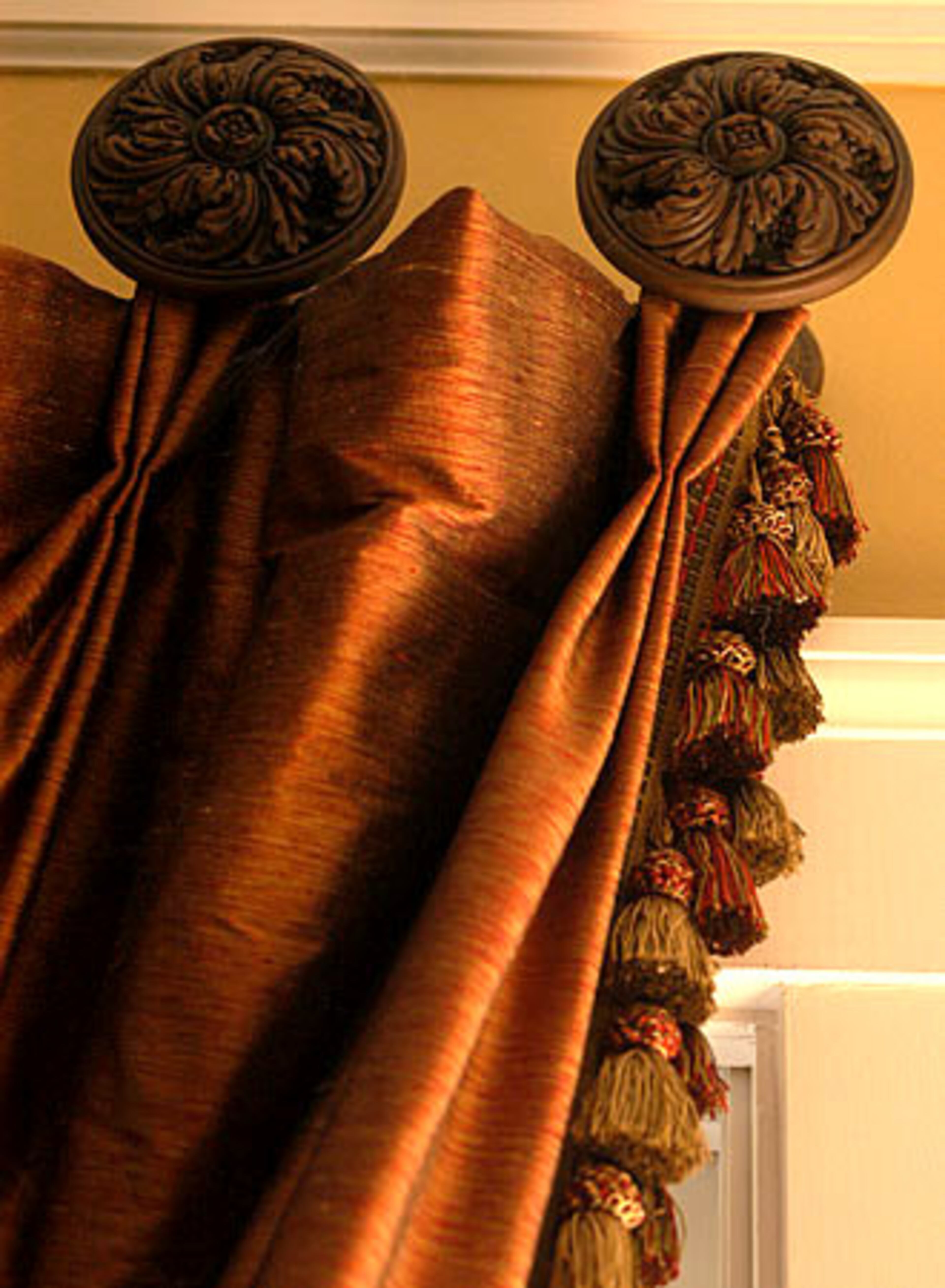 Decorative hardware complements rich-colored curtains in a formal sitting area in the Haase home.