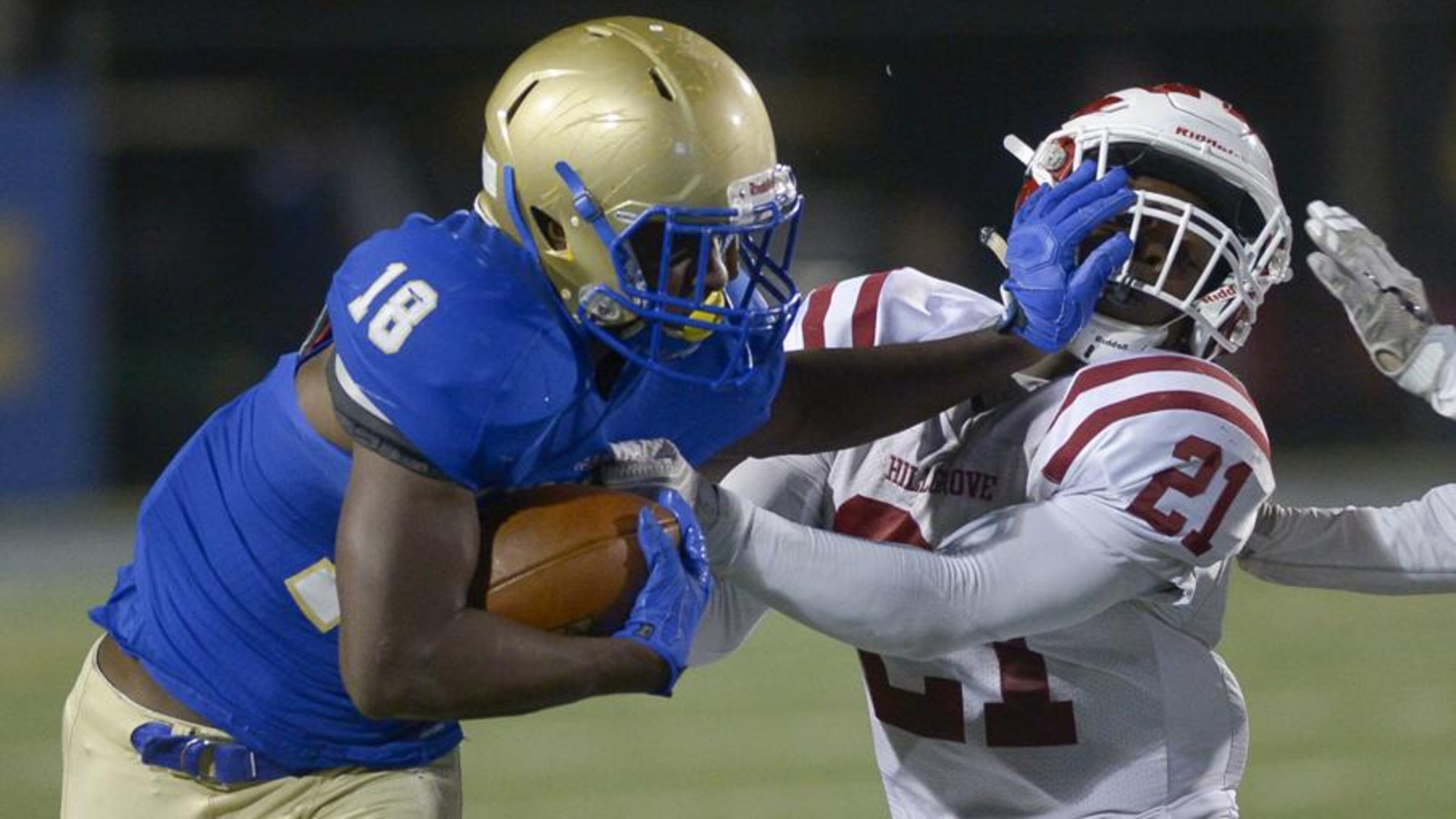 Powder Springs, Ga. -- McEachern sophomore RB Paris Brown (18) stiff arms Hillgrove sophomore S Lance Wise (21) as he runs the ball in the second halfFriday, November 4, 2016. SPECIAL/Daniel Varnado