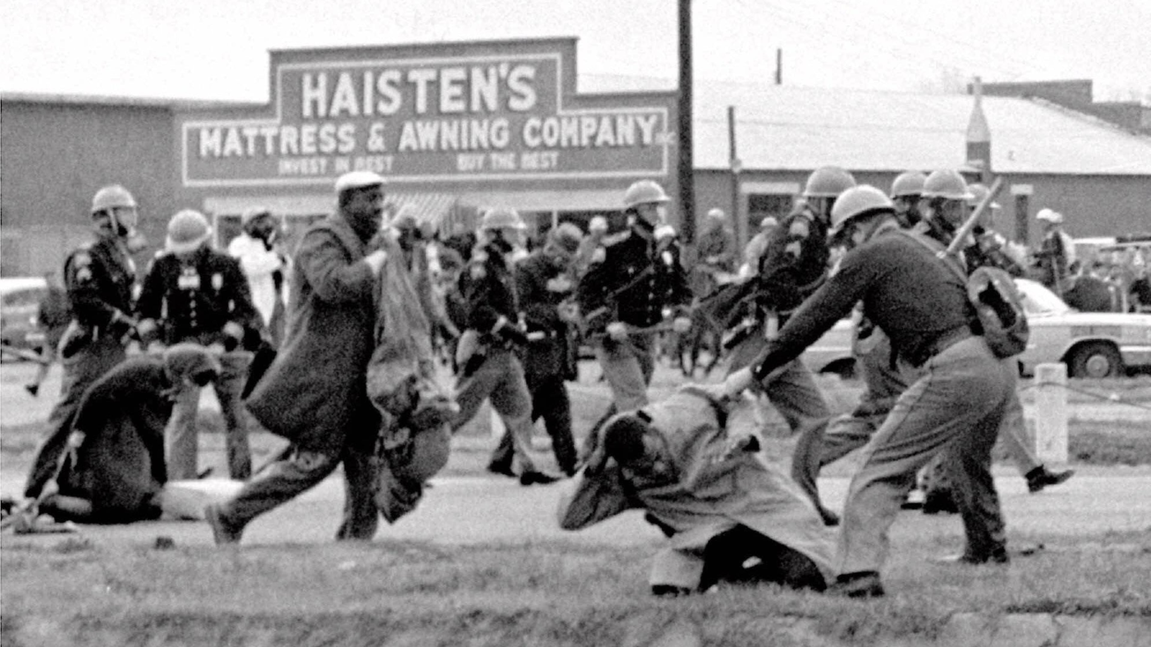 Alabama state troopers swing nightsticks to break up a civil rights voting march in Selma, Ala., in this March 7, 1965, file photo. John Lewis, front right, of the Student Nonviolent Coordinating Committee is put on the ground by a trooper. (Associated Press file photo)
