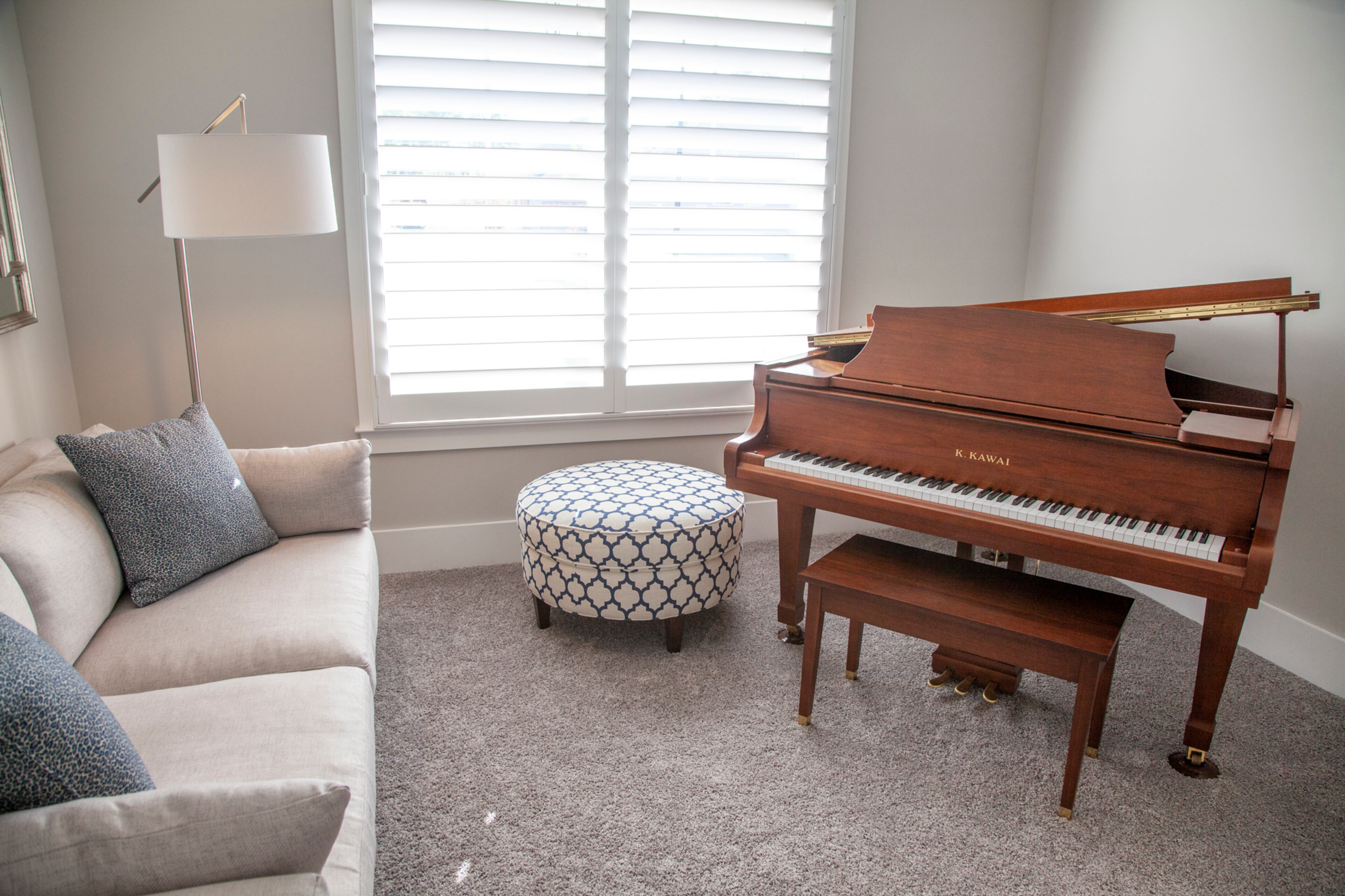The Kawai grand piano fit perfectly in the sitting room alongside a couch from Pottery Barn and an ottoman from Bassett, the homeowners said.