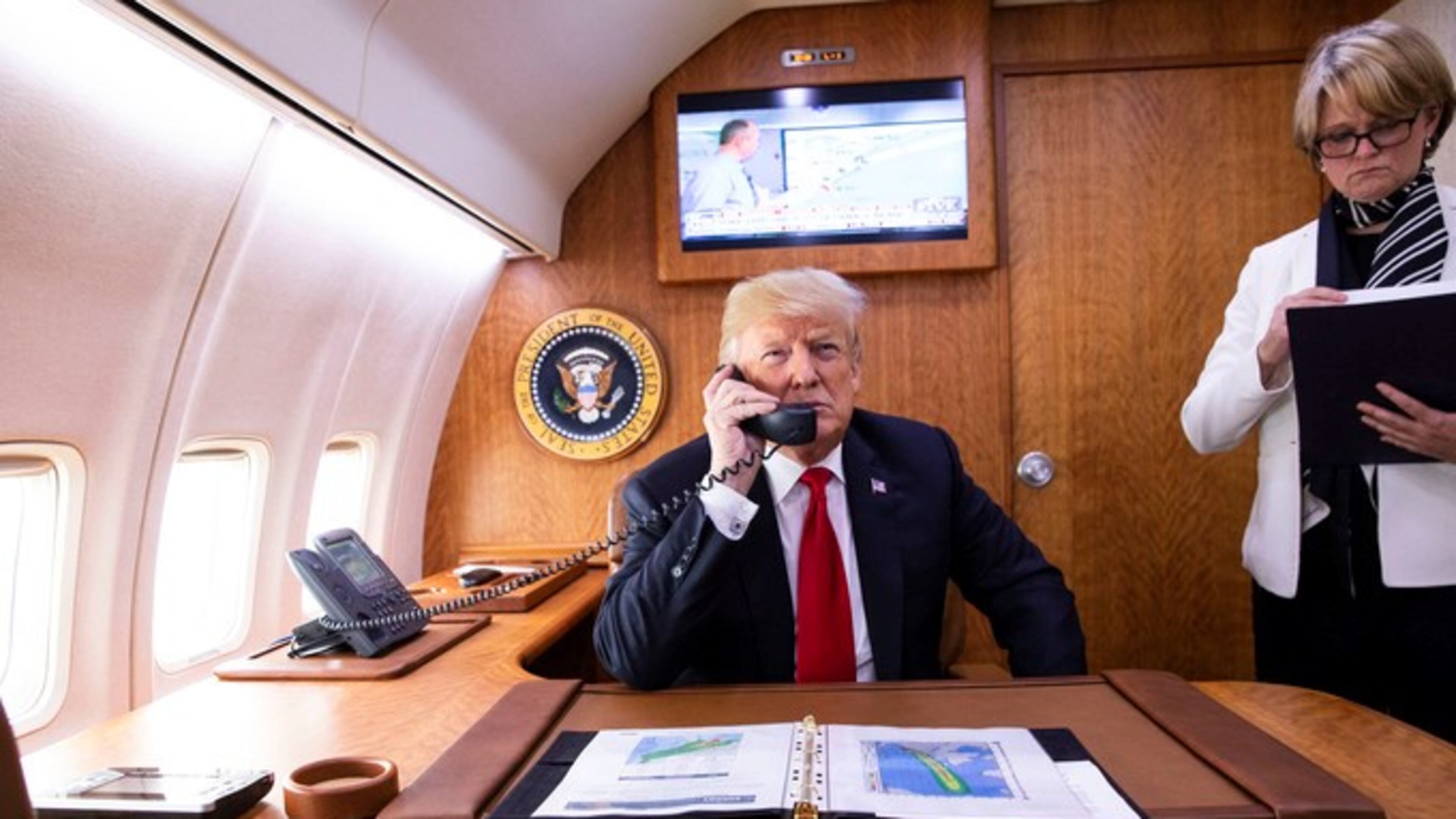President Donald Trump, joined by National Security Council Deputy Chief of Staff Joan O’Hara, talks to Gov. Nathan Deal about Hurricane Michael aboard Air Force One on Oct. 10, 2018. (Official White House Photo by Joyce N. Boghosian)