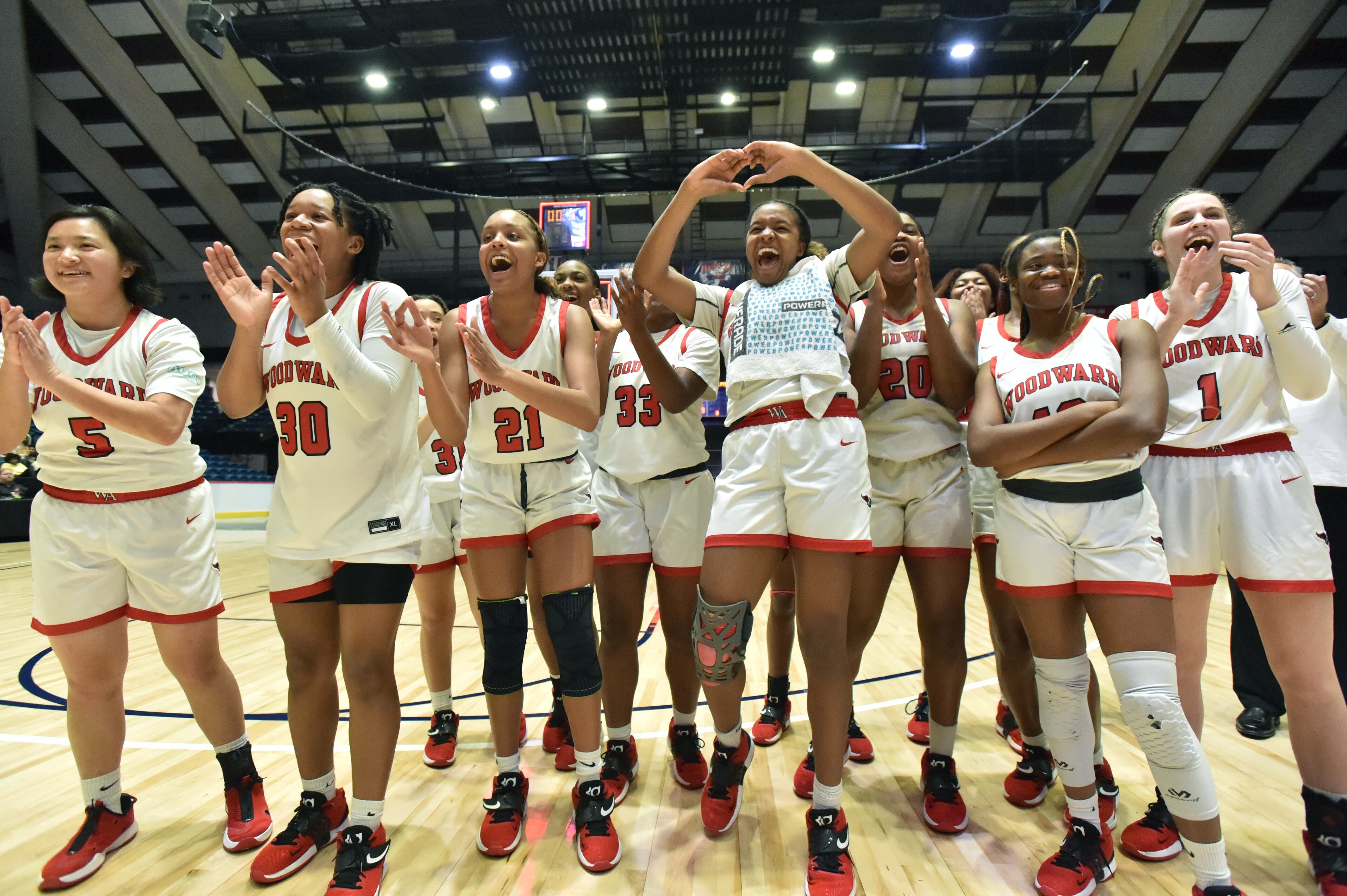 Woodward Academy players celebrate their victory over Forest Park during the 2022 GHSA State Basketball Class AAAAA Girls Championship game at the Macon Centreplex in Macon on Thursday, March 10, 2022. (Hyosub Shin / Hyosub.Shin@ajc.com)