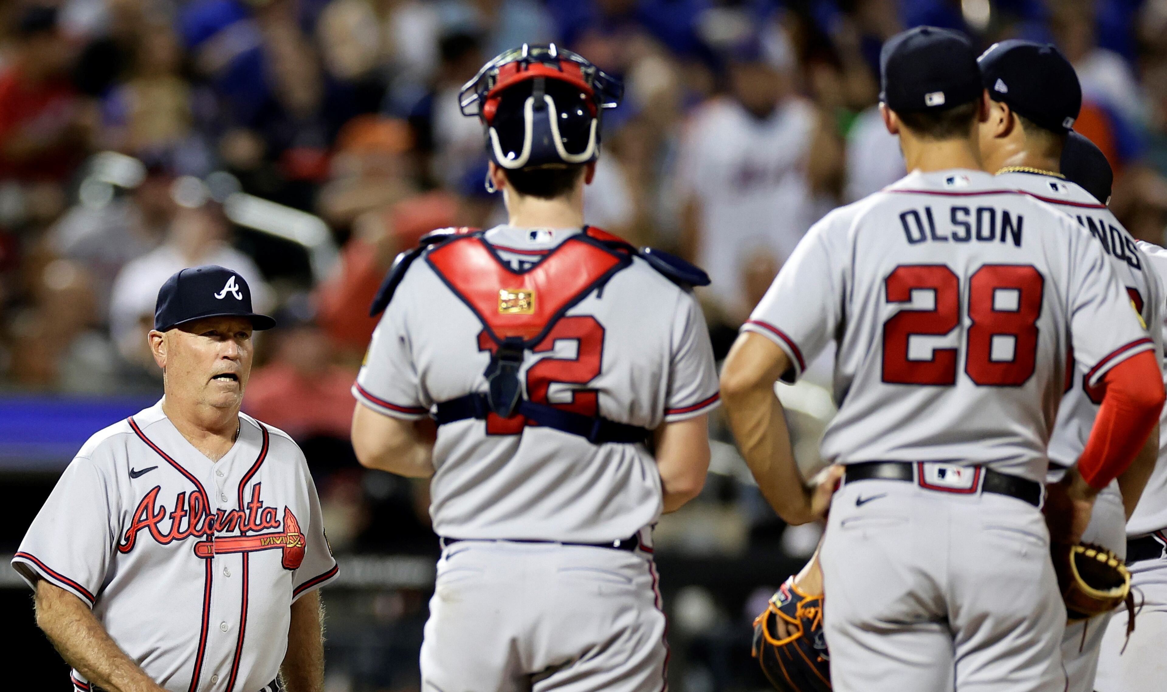 Braves manager Brian Snitker walks to the mound to relieve starter Yonny Chirinos (right) during the fifth inning of Sunday's game against the Mets. New York avoided a four-game series sweep by defeating Atlanta 7-6. (AP Photo/Adam Hunger)