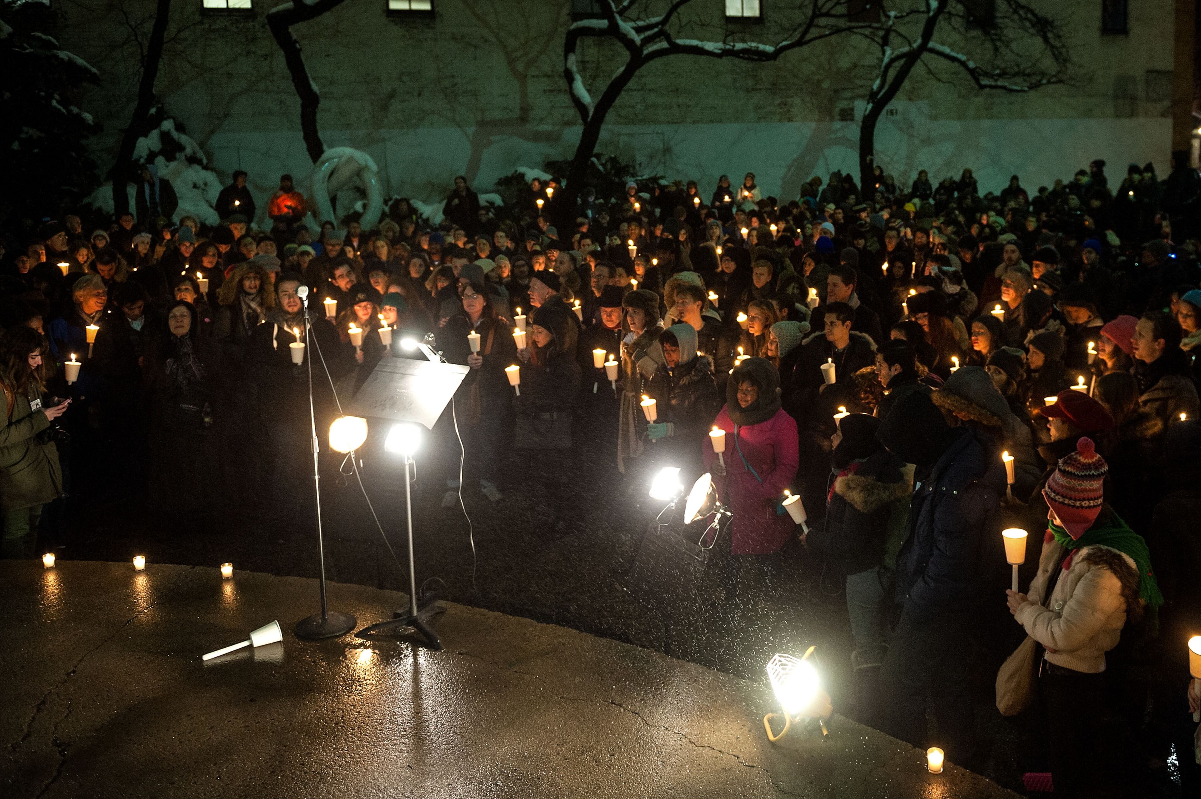 People gather to pay their respects during the Candlelight Vigil For Philip Seymour Hoffman at the Labyrinth Theater Company on February 5, 2014 in New York City.