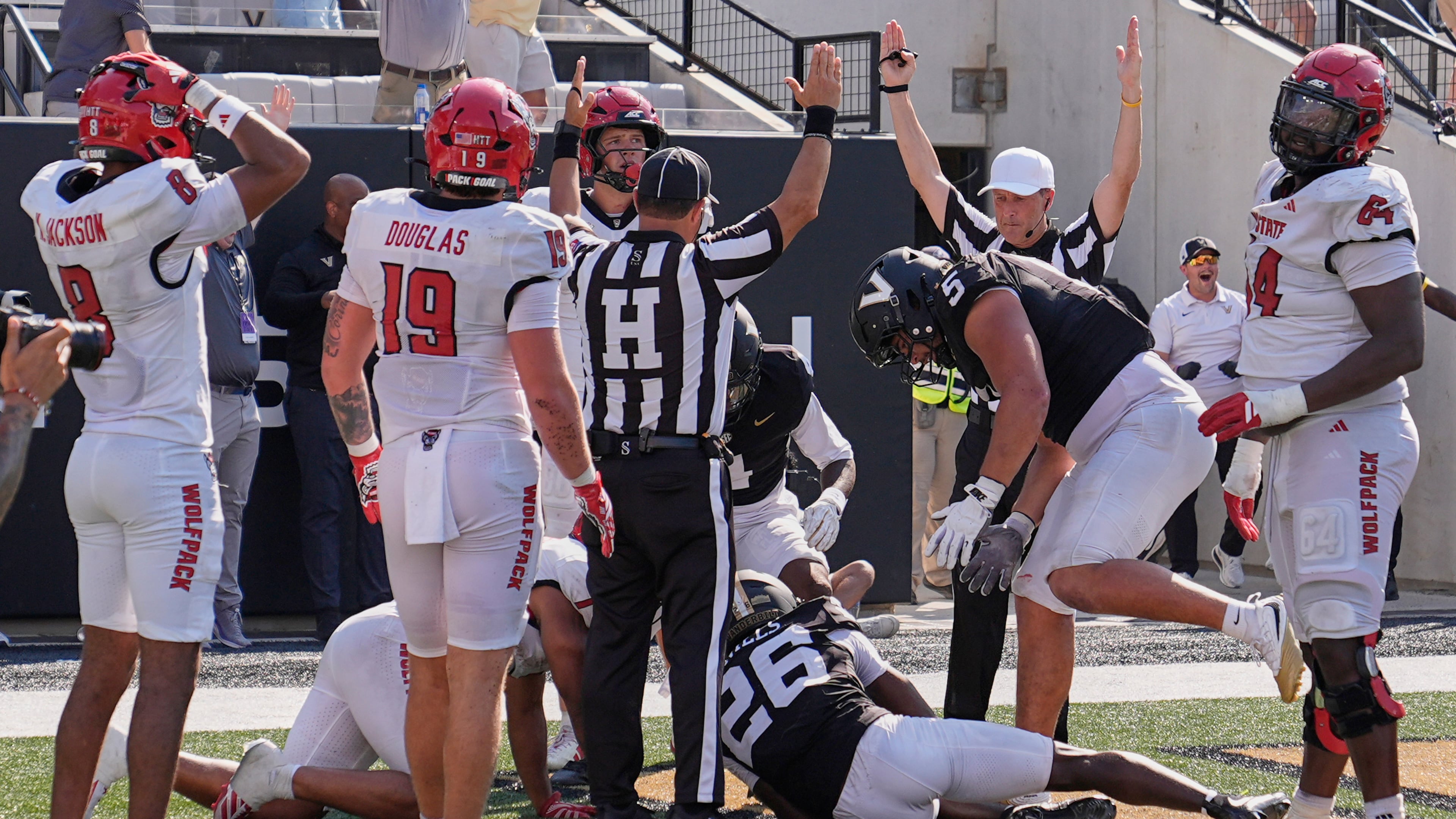 Officials signal touchdown after Vanderbilt cornerback Cayden Daniels (26) recovered a North Carolina State fumble in the end zone during the second half of an NCAA college football game Saturday, Sept. 19, 2026, in Nashville, Tenn. (AP Photo/George Walker IV)