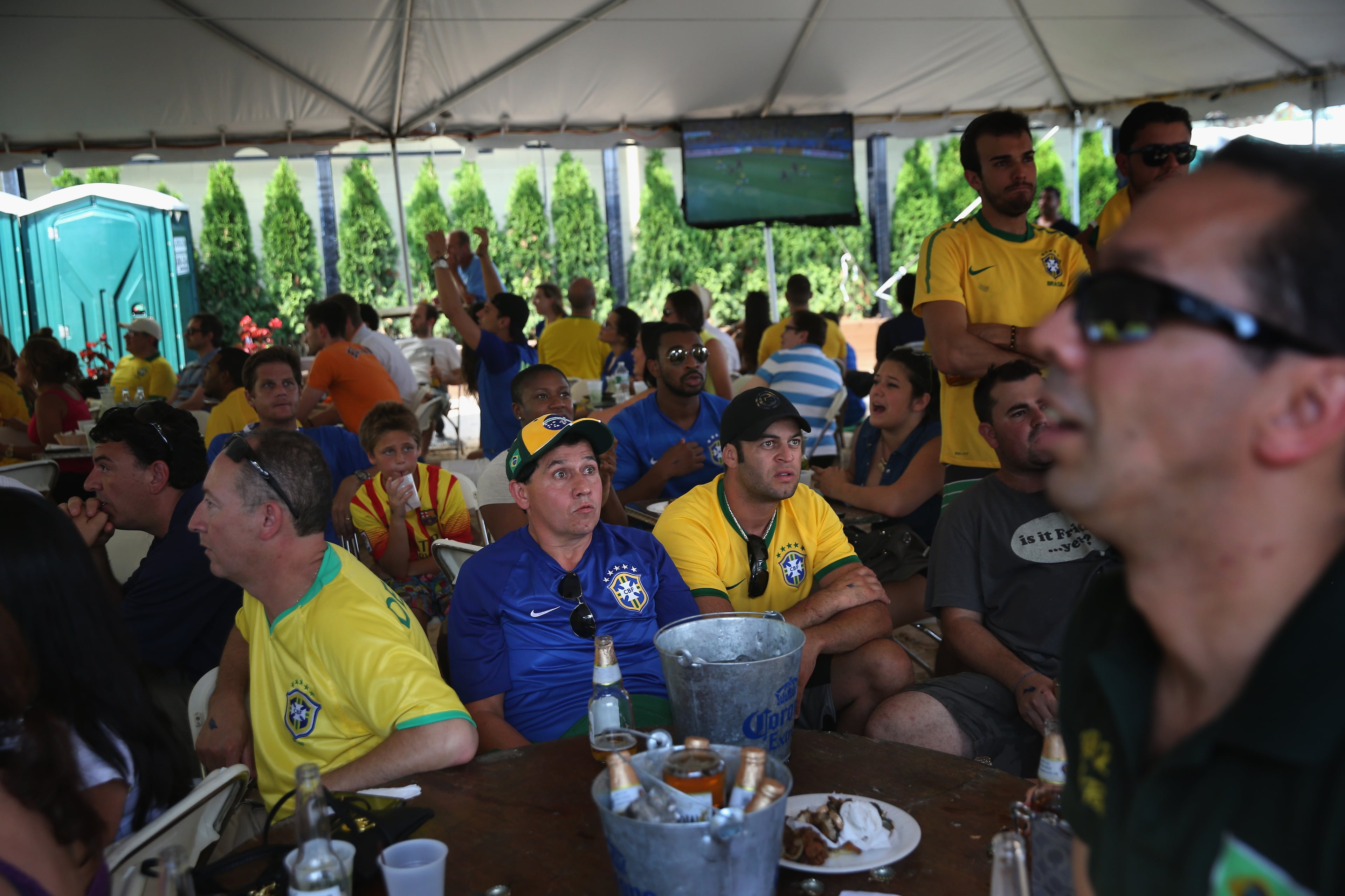 Brazilian fans watch as their team falls farther behind during the semifinal World Cup game against Germany on July 8, 2014 in Port Chester, United States. Fans, mostly for Brazil, gathered at the Copacabana Restaurant in Westchester County to watch on outdoor TV screens. (Photo by John Moore/Getty Images)