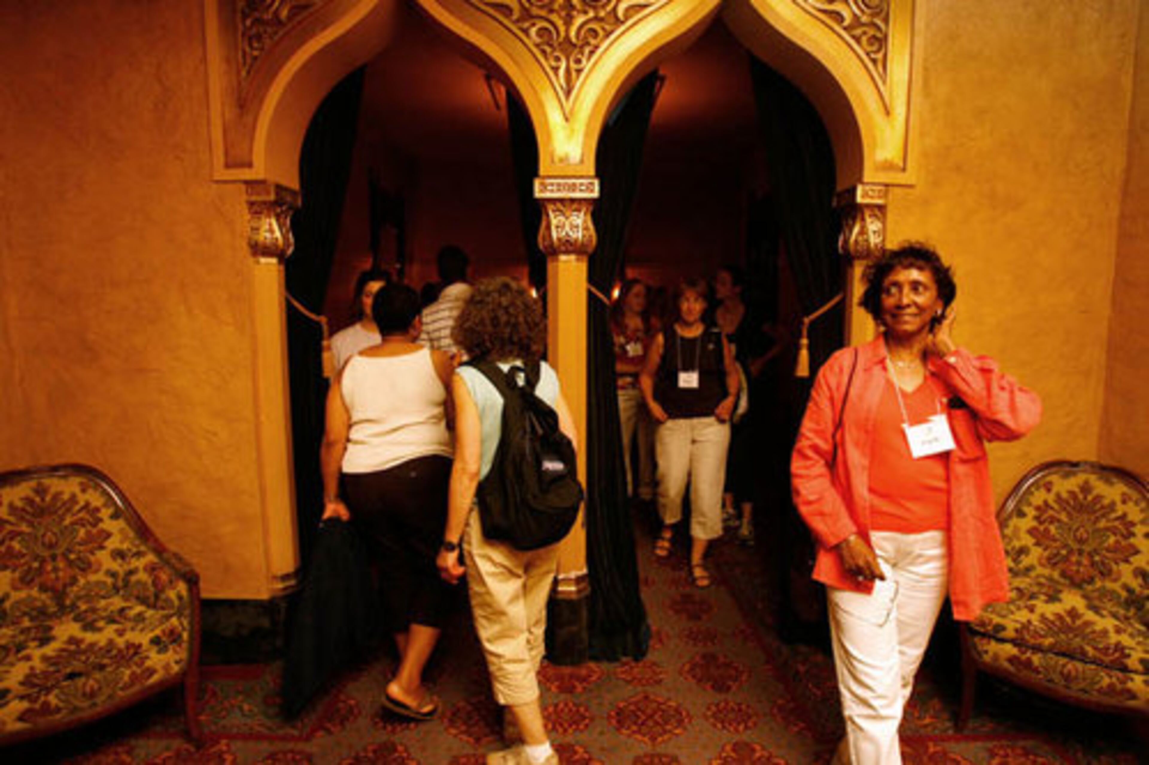 Edith Harris (right), a retired teacher from Nashville, walks through the Ladies Lounge at the Fox Theatre. Only white patrons could use the lounge during Jim Crow.