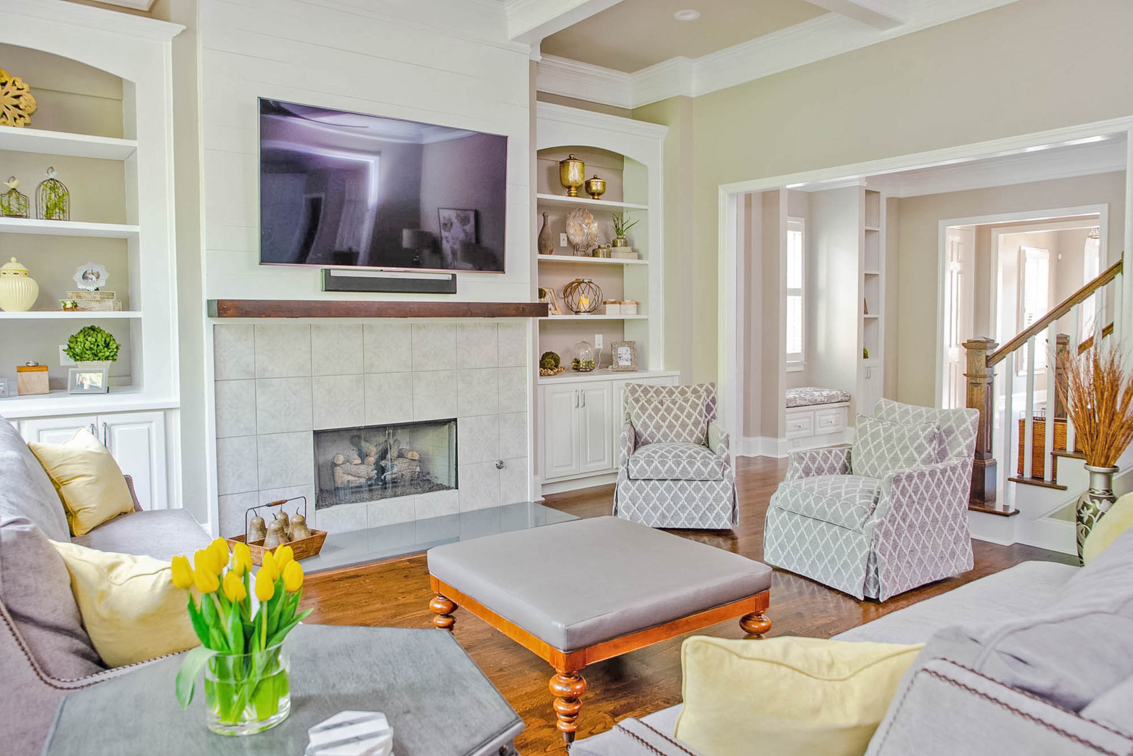 Designer Linda Castle of Decorated Designs helped the homeowners select the swivel club chairs, sofas and ottoman from Fairfield for their updated family room. It's open to the stairwell, which also was freshened up in the renovations.
