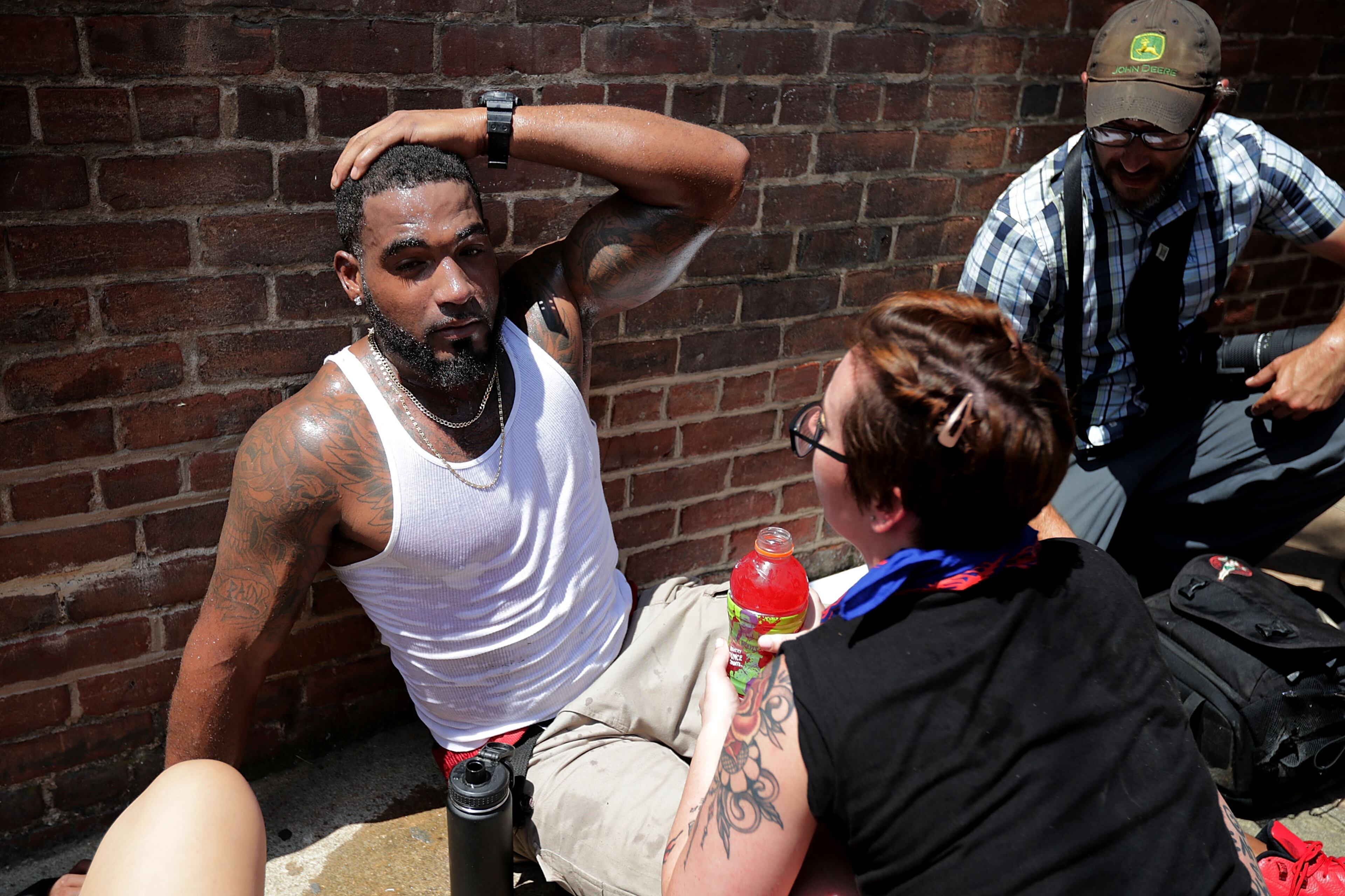CHARLOTTESVILLE, VA - AUGUST 12: Rescue workers and volunteer medics tend to people who were injured when a car plowed through a crowd of anti-facist counter-demonstrators marching through the downtown shopping district August 12, 2017 in Charlottesville, Virginia. The car plowed through the crowed following the shutdown of the "Unite the Right" rally by police after white nationalists, neo-Nazis and members of the "alt-right" and counter-protesters clashed near Lee Park, where a statue of Confederate General Robert E. Lee is slated to be removed. (Photo by Chip Somodevilla/Getty Images)