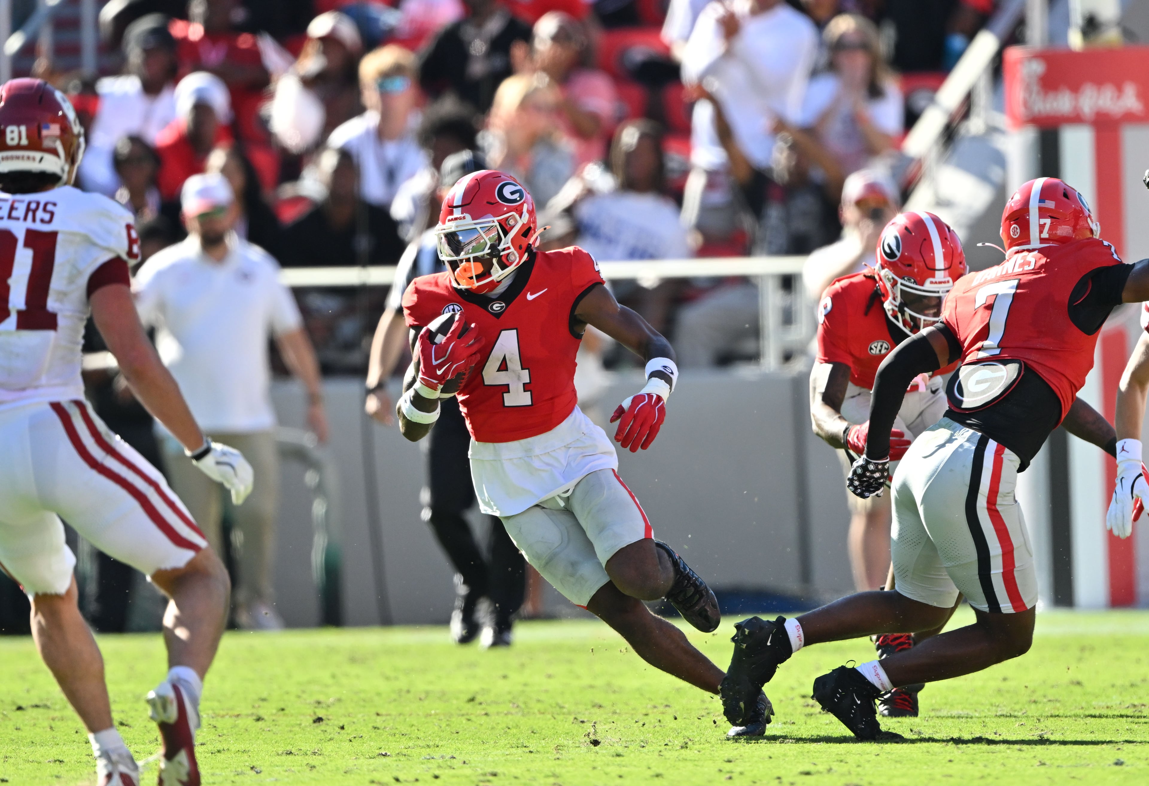 Georgia defensive back KJ Bolden (center) intercepts an Oklahoma pass and runs it back for a touchdown during the first half in an NCAA football game at Sanford Stadium on Saturday, Sept. 26, 2026, in Athens, Ga. Georgia went on to win 41-13. (Hyosub Shin/AJC)
