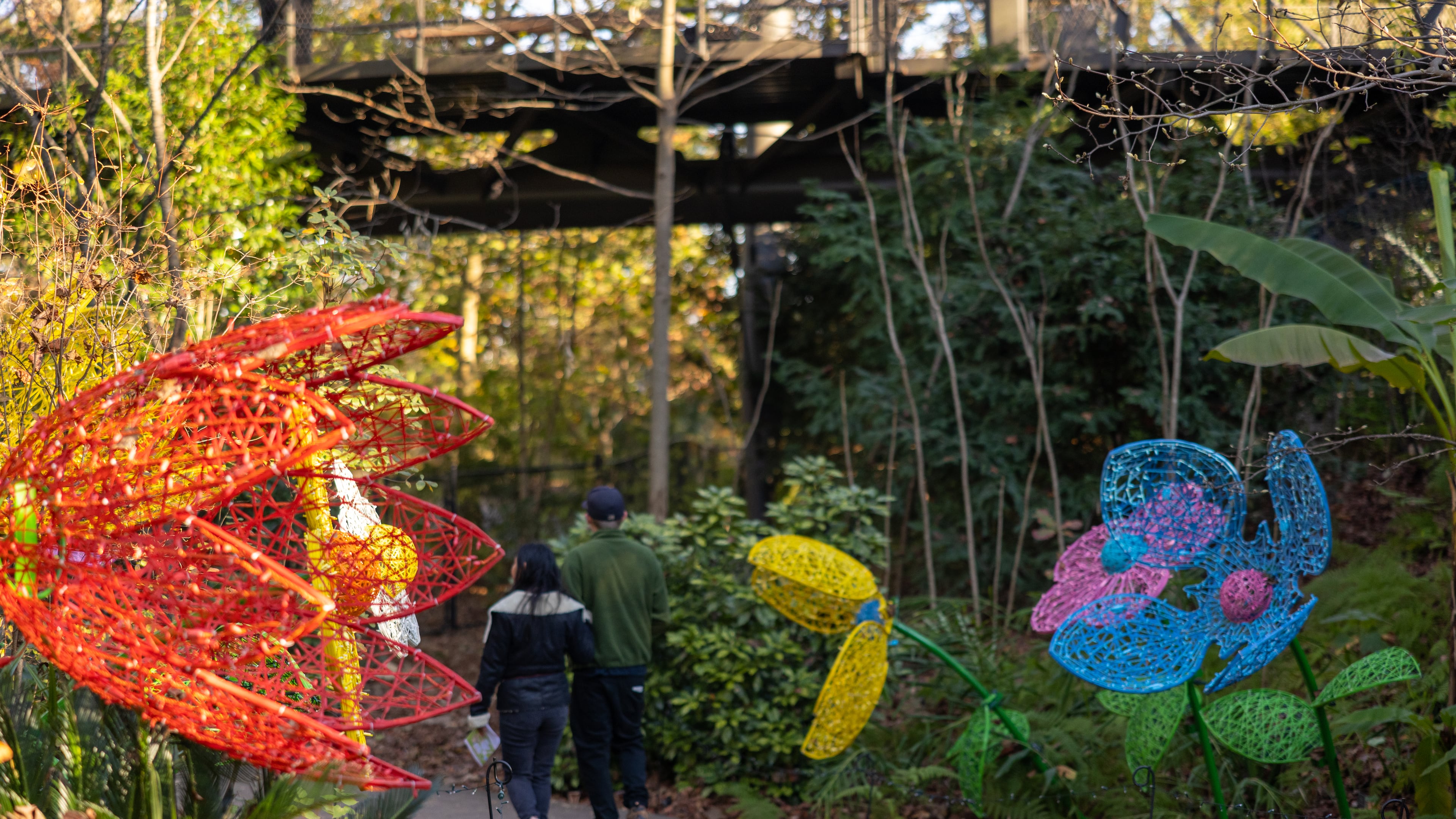 A couple walk by flower sculptures at Atlanta Botannical Garden on November 17, 2022