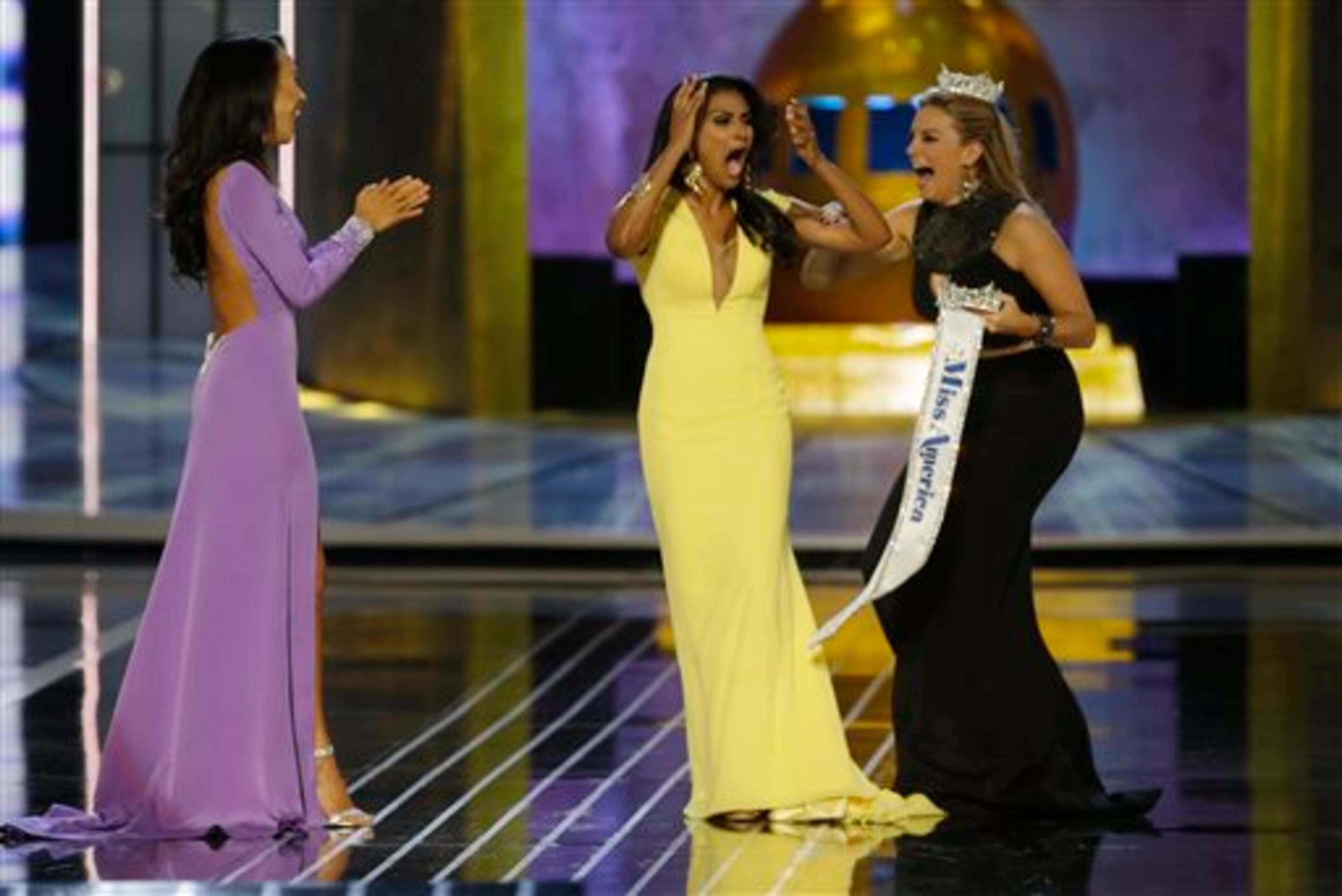 Miss New York Nina Davuluri, center, reacts after being named Miss America 2014 pageant as Miss California Crystal Lee, left, and Miss America 2013 Mallory Hagan celebrate with her, Sunday, Sept. 15, 2013, in Atlantic City, N.J. (AP Photo/Mel Evans)