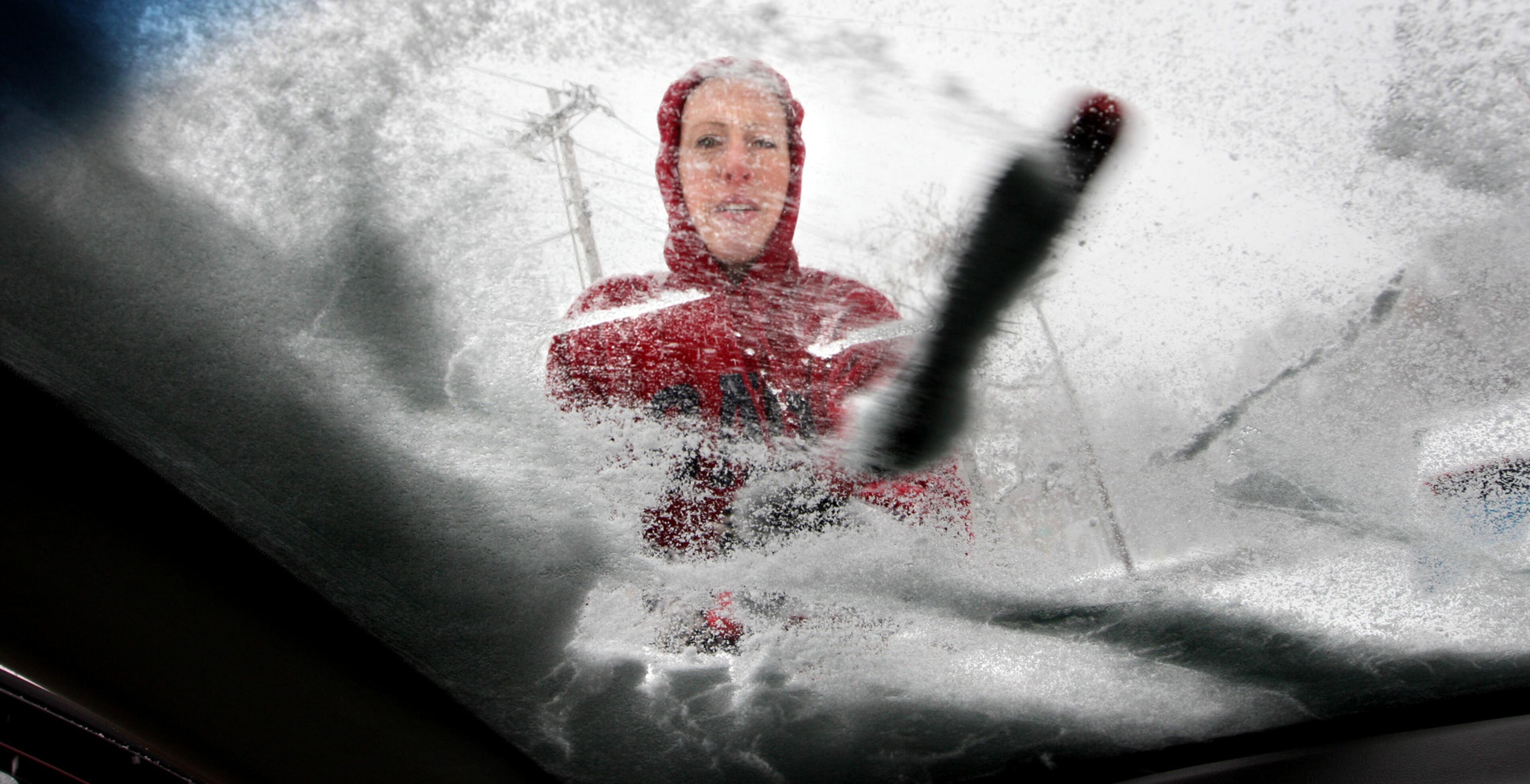 Shenandoah University student Kim Hyden of Staunton, Va. brushes several inches of snow from her windshield to head home after studying in the anatomy lab for her physician's assistant final exams in Winchester, Va. Sunday, Dec. 8, 2013. Rain, snow, sleet and freezing rain began to glaze most of the Mid-Atlantic on Sunday, with officials urging people to stay off the roads, as North Texas and other states shook off the early remnants of the powerful storm.
