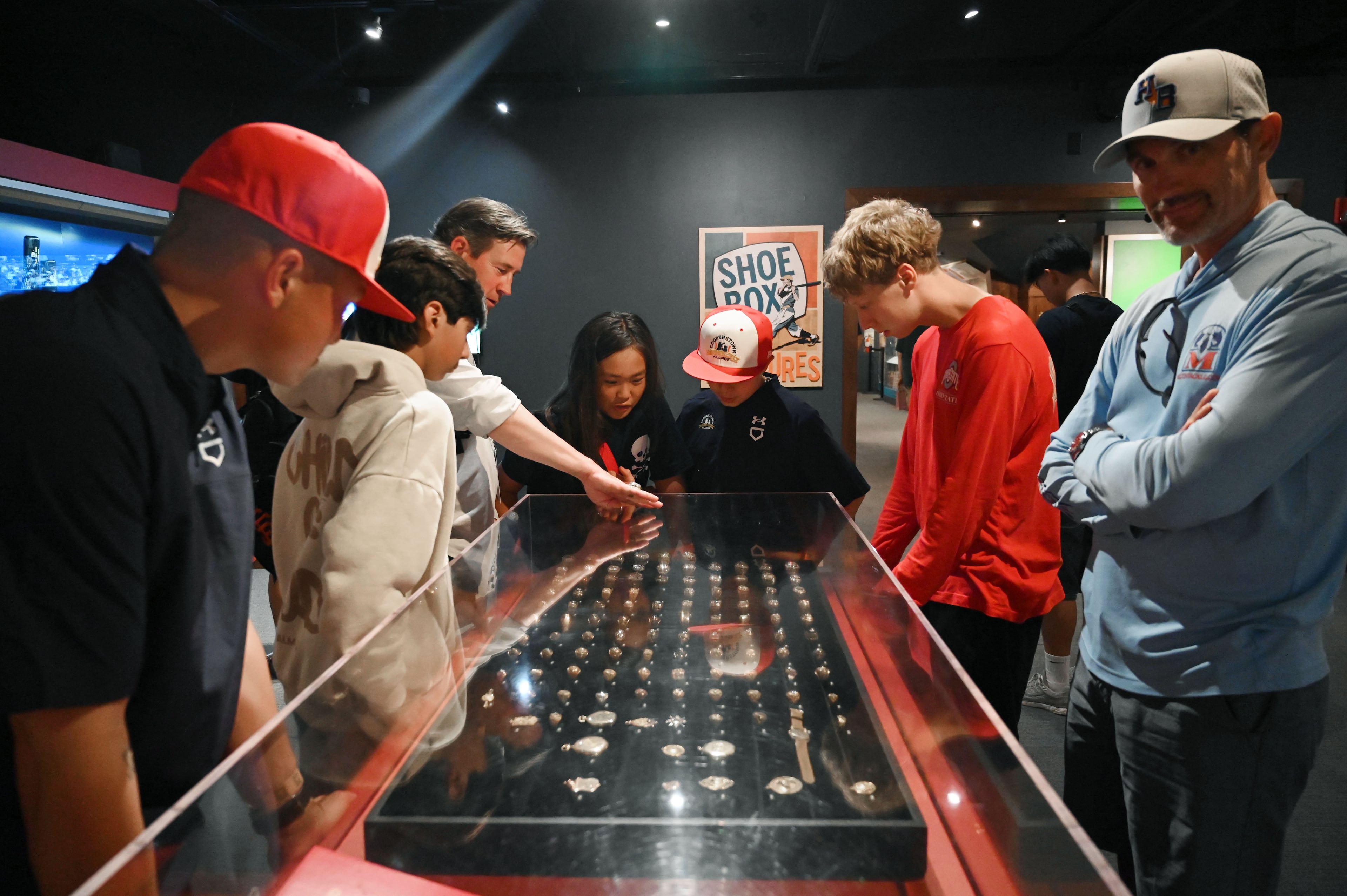 Baseball fans check out a jewelry exhibit at the National Baseball Hall of Fame and Museum on Friday, July 24, 2026, in Cooperstown, N.Y. Andruw Jones will be inducted into the National Baseball Hall of Fame on Sunday as part of the Class of 2026, alongside Carlos Beltrán and Jeff Kent. He is recognized as one of the greatest center fielders in baseball history. Jones will become the 12th player with ties to the Atlanta Braves to be inducted into the Hall of Fame. (Hyosub Shin/AJC)