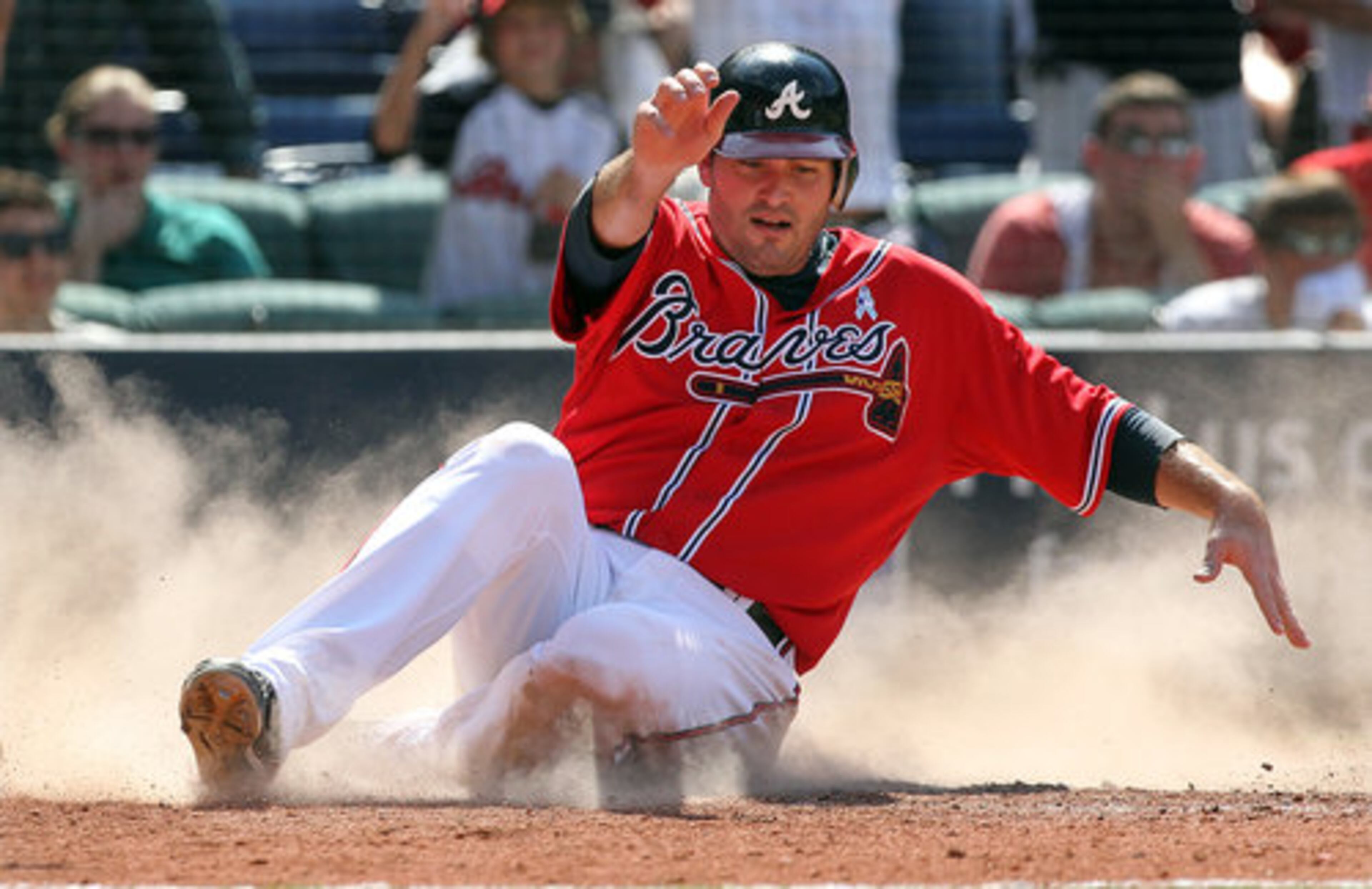 Atlanta Braves (25) Troy Glaus slides home scoring on a 2-run double by (20) Eric Hinske as the Braves take a 7-5 lead over the Kansas City Royals during 8th inning action at Turner Field in Atlanta on Sunday, June 20, 2010.