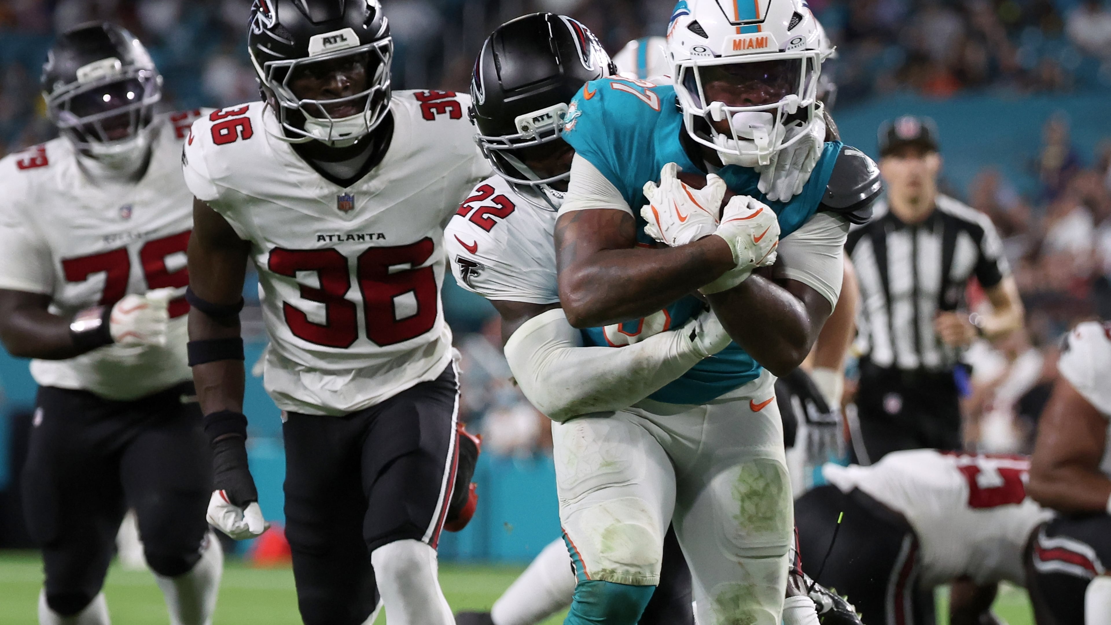 Falcons defensive back Malcolm DeWalt IV (second from left) runs after Miami Dolphins running back Carlos Washington Jr. (foreground) during the second half of an NFL preseason game, Friday, Aug. 28, 2026, in Miami Gardens, Fla. He secured a spot on the Falcons roster over eight players with more NFL experience. (David Santiago/AP)