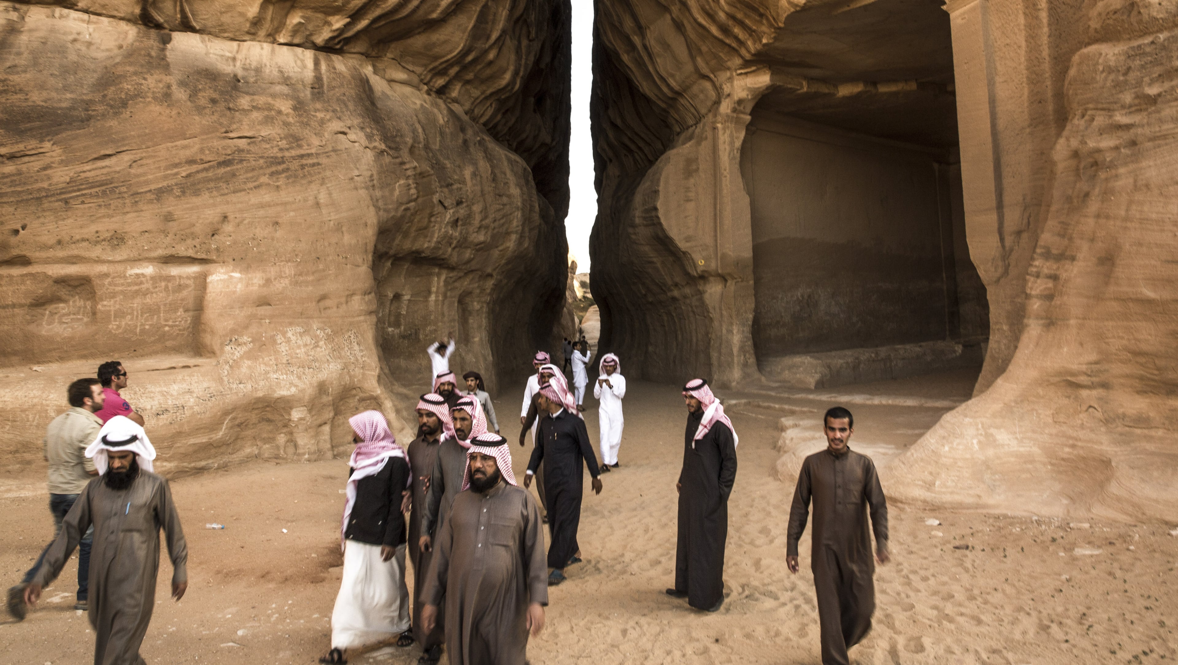 Tourists visit the ancient ruins of Mada’in Saleh in the Al Madinah Region of Saudi Arabia. In a region where countries like Egypt, Jordan and the United Arab Emirates have invested to make tourism pillars of their economies, Saudi Arabia stands apart, and for good reason. (Bryan Denton/The New York Times)
