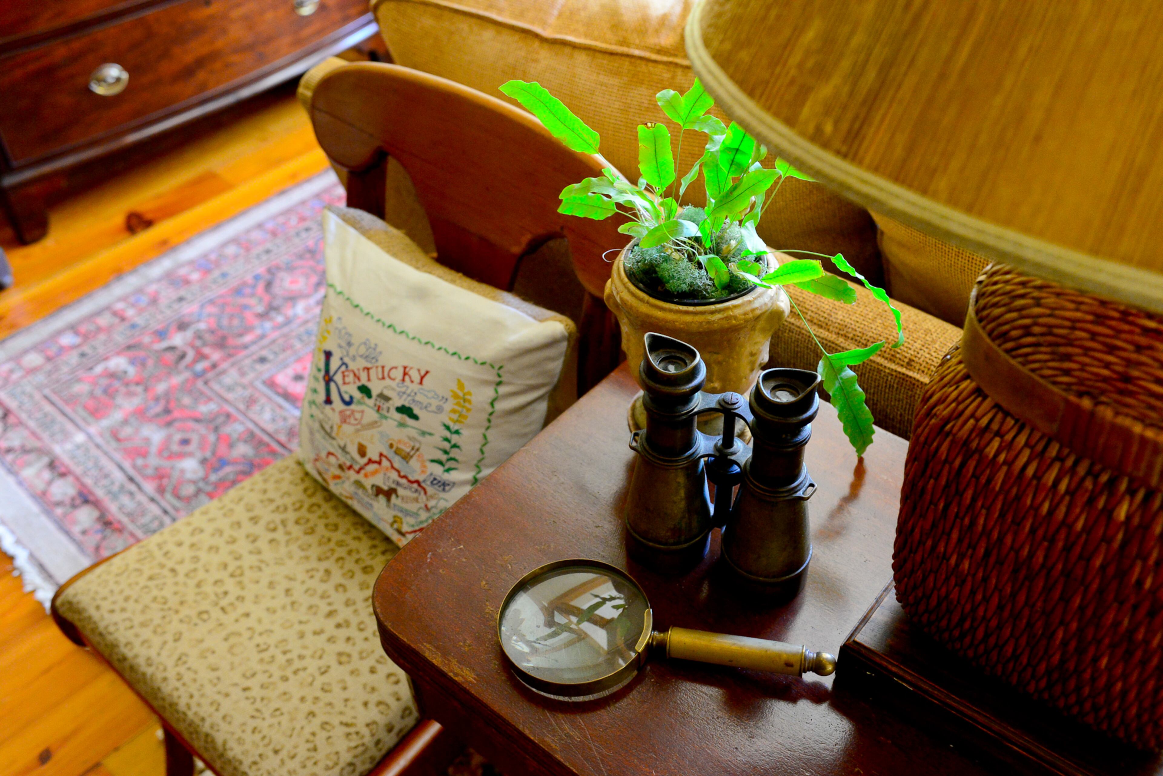 The binoculars and magnifying glass belonged to Ed Barber's great-aunt. The flip-top table can double in size when entertaining. The Kentucky pillows have a personal connection, as homeowner Lu Barber grew up on a farm in the state.