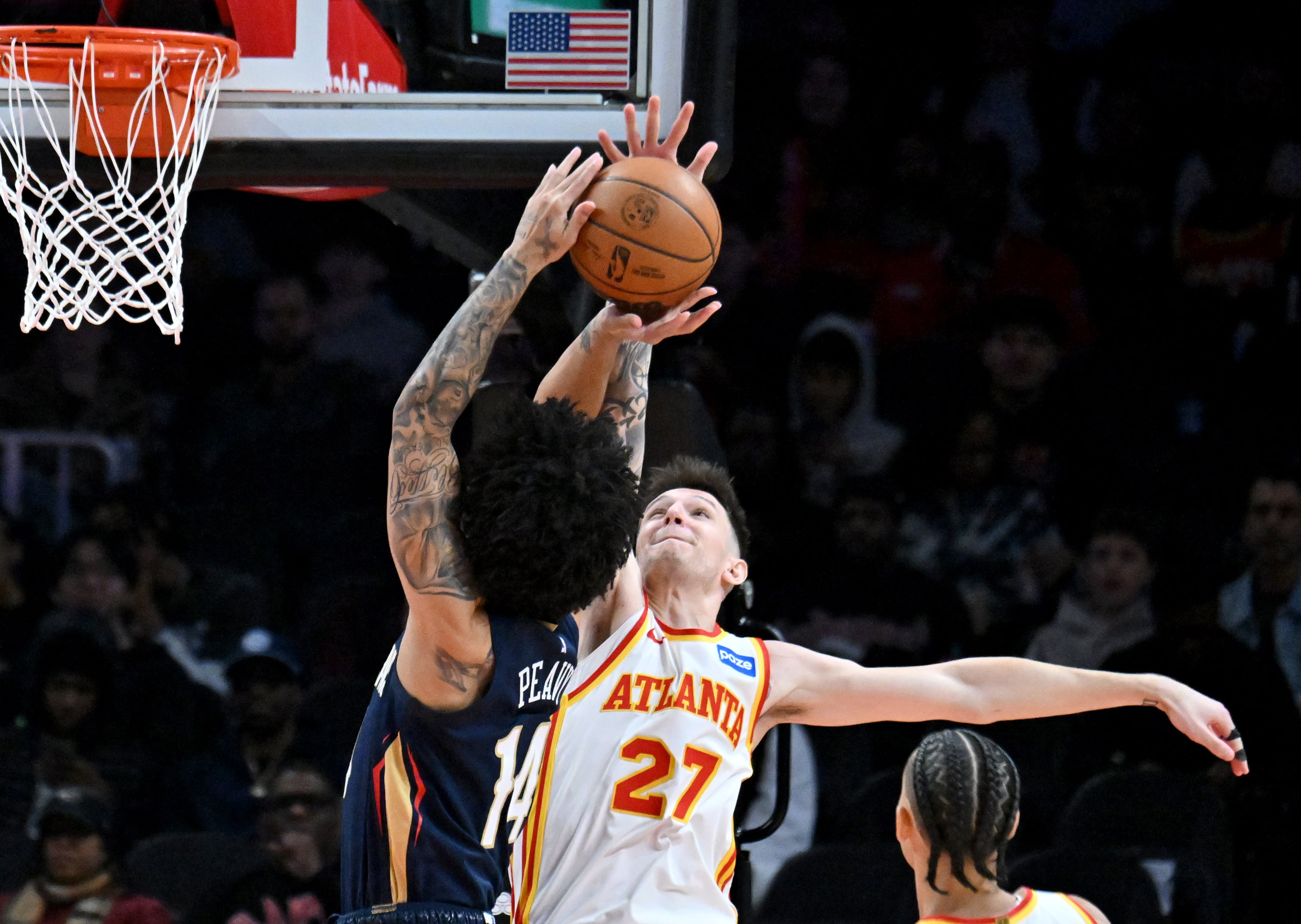 Atlanta Hawks guard Vít Krejčí (27) knocks the ball away from New Orleans Pelicans guard/forward Micah Peavy (14) during the first half in an NBA basketball game at State Farm Arena, Wednesday, Jan. 7, 2026, in Atlanta. (Hyosub Shin/AJC)