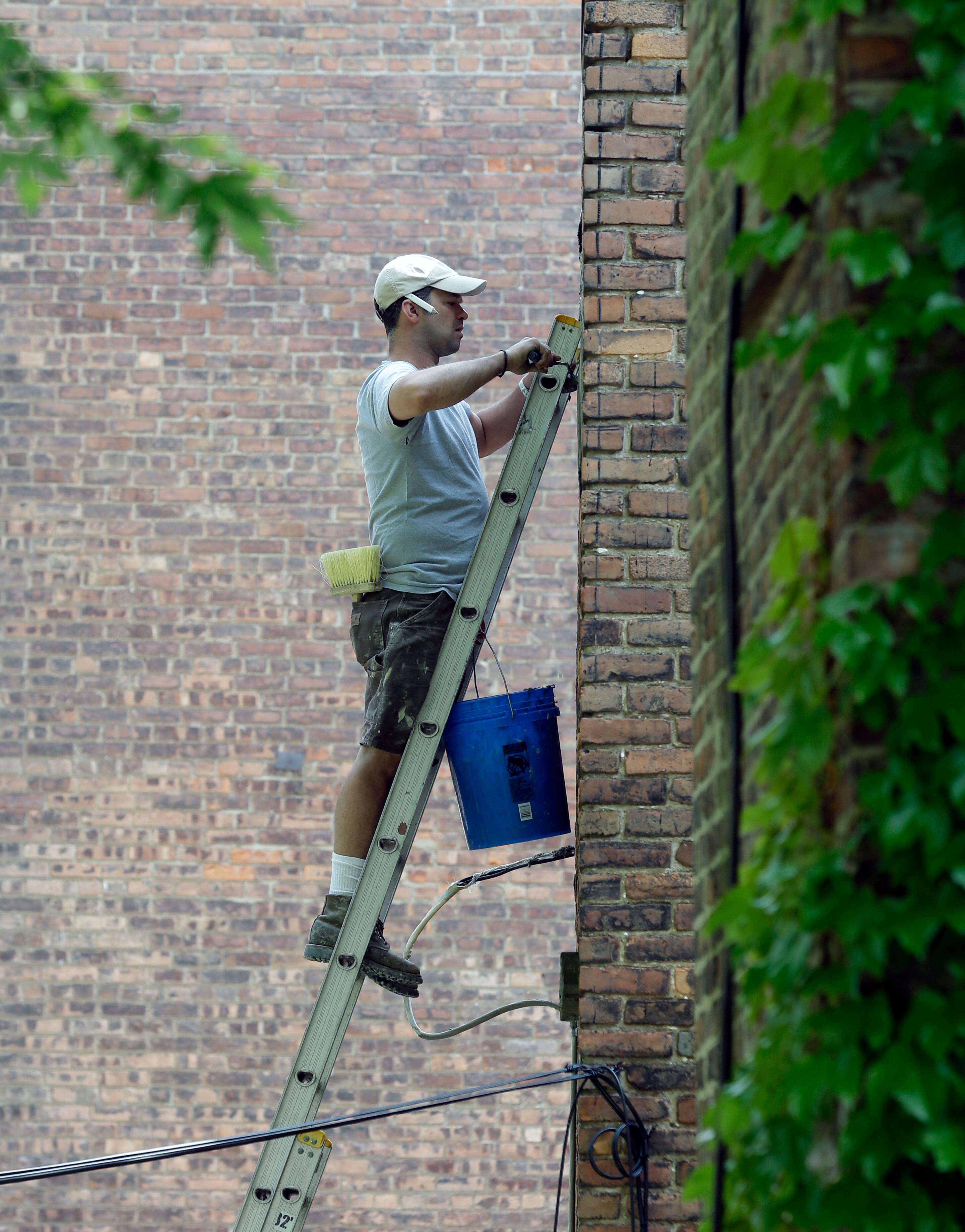 Mike Griffiths does masonry repair work on the brick wall of a house on Tuesday, May 27, 2014, in Albany, N.Y. (AP Photo/Mike Groll)