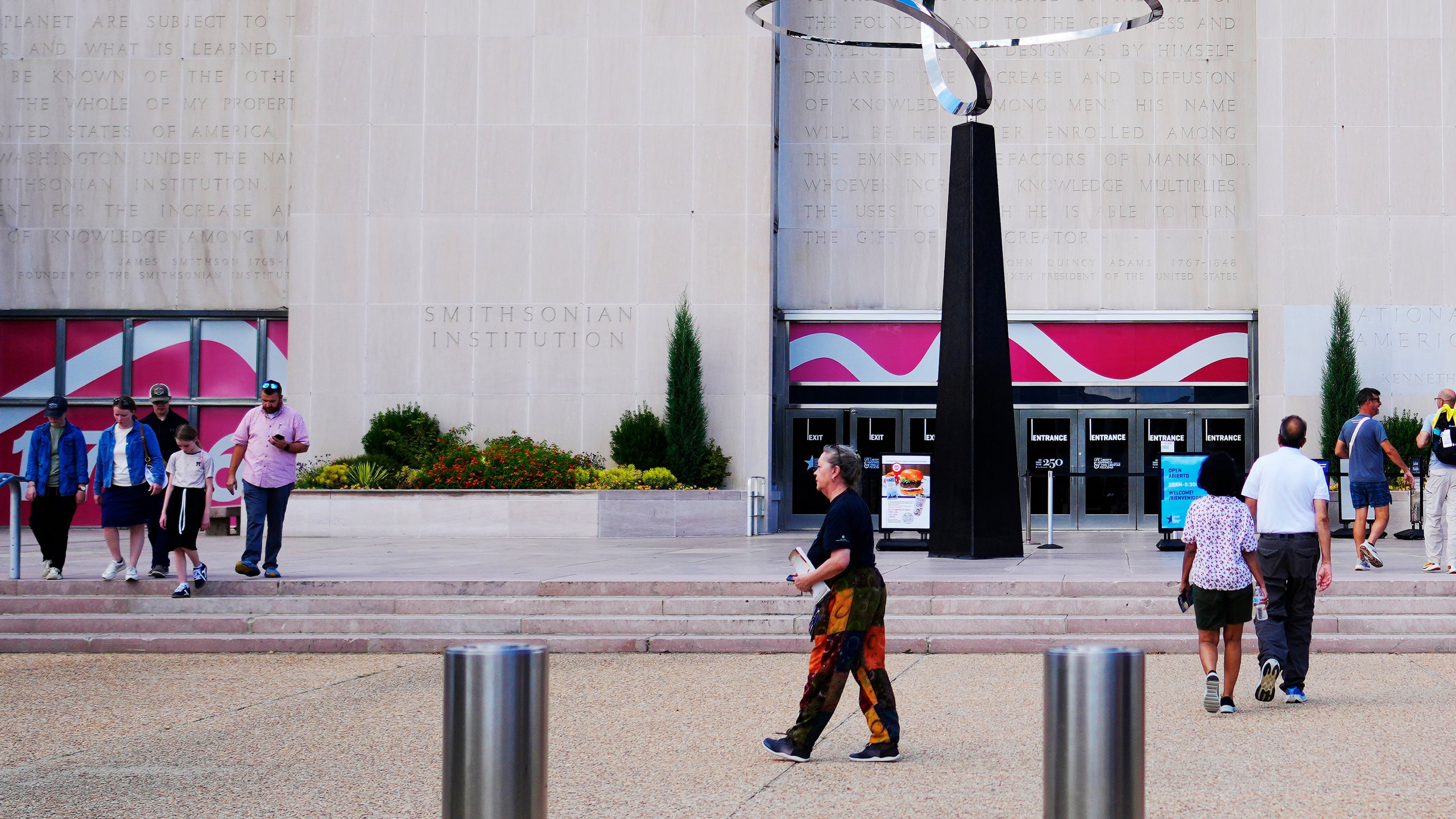 People walking past the "Infinity" sculpture outside the Smithsonian National Museum of American History on the National Mall in Washington, Tuesday, Sept. 8, 2026. (AP Photo/Pablo Martinez Monsivais)