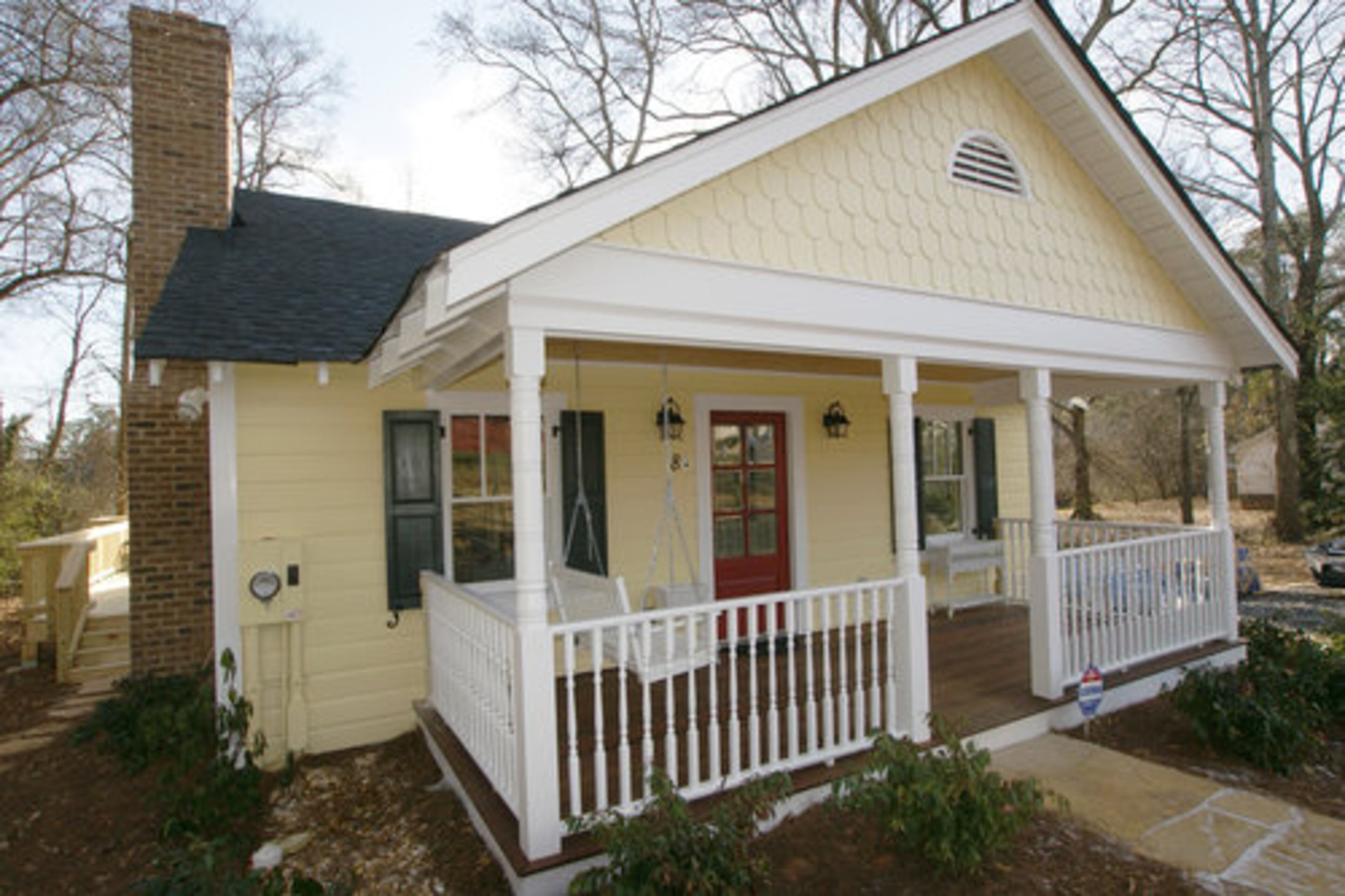 AFTER: Thoughtful, historically-sourced details such as original siding, French gutters, new functional shutters and well-chosen paint colors transform this Roswell home into a bright, appealing winner.