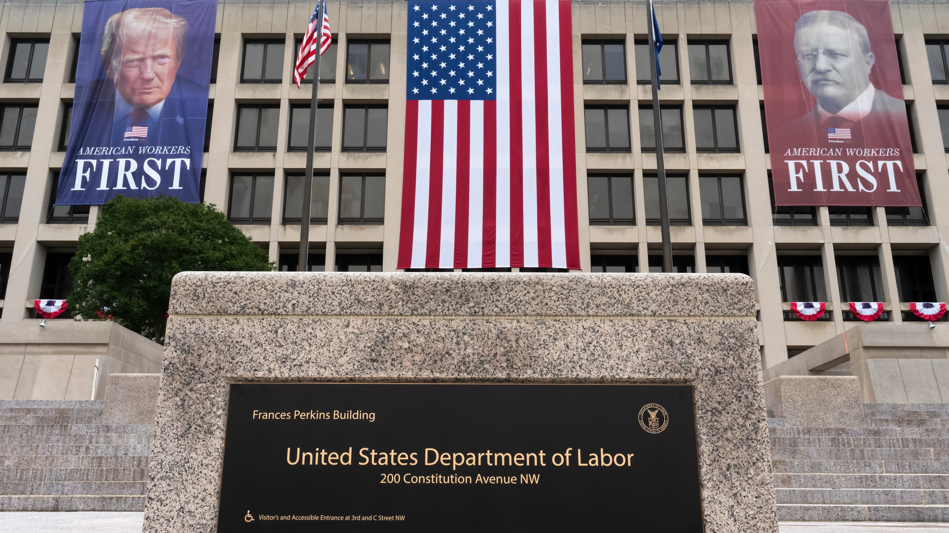 FILE - Portraits of Presidents Donald Trump and Theodore Roosevelt hang above the Department of Labor in Washington, July 7, 2026. (AP Photo/J. Scott Applewhite, File)