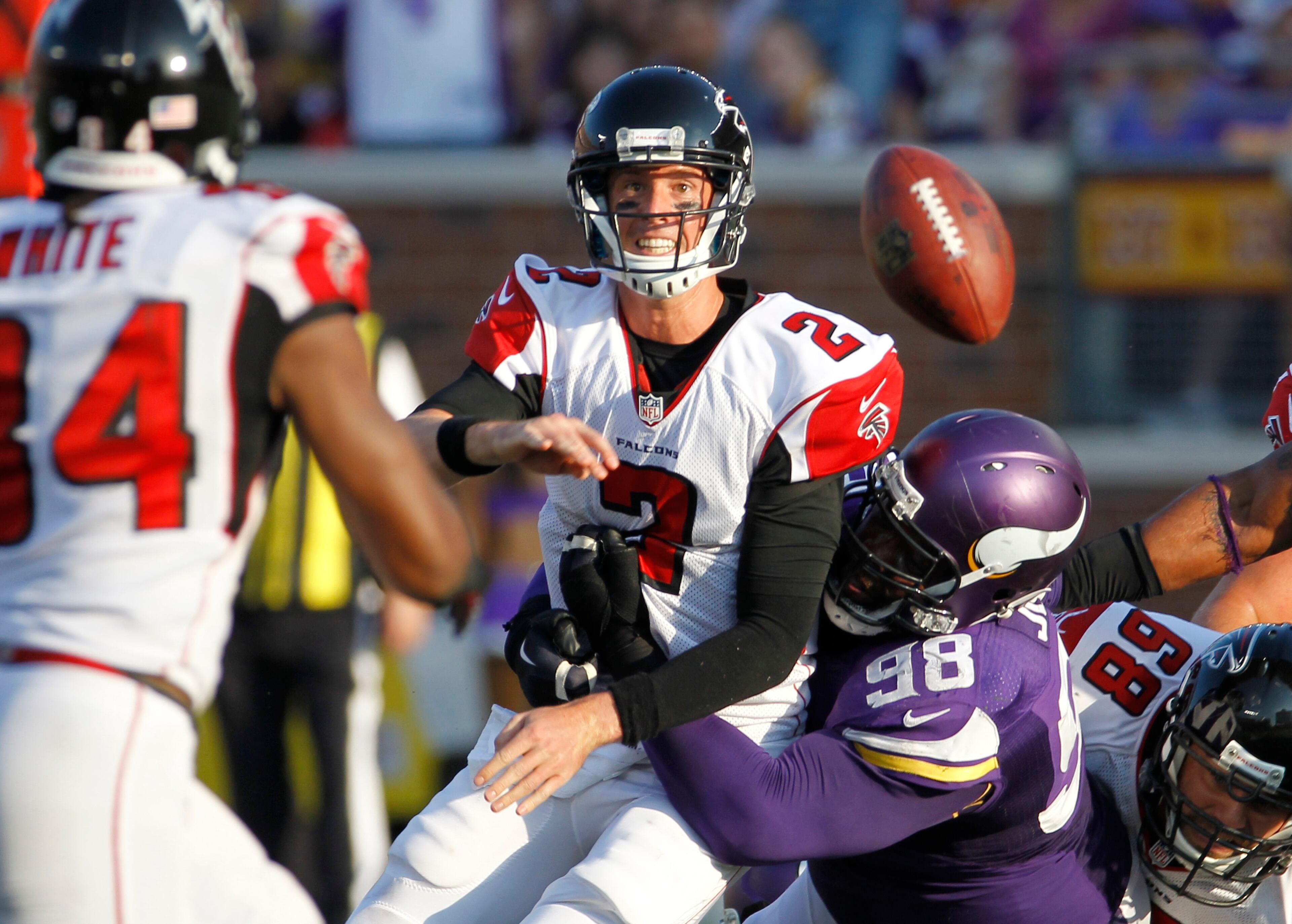 Atlanta Falcons quarterback Matt Ryan passes the ball as he is hit by Minnesota Vikings defensive tackle Linval Joseph (98) during the second half of an NFL football game, Sunday, Sept. 28, 2014, in Minneapolis. (AP Photo/Ann Heisenfelt)