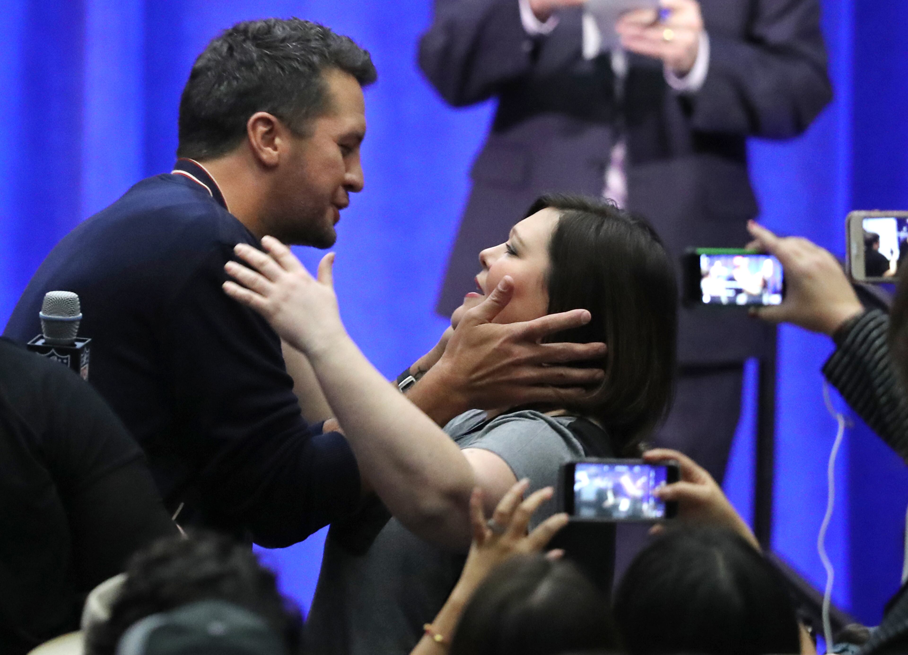 Luke Bryan hugs a woman in the audience during Thursday's press conference.