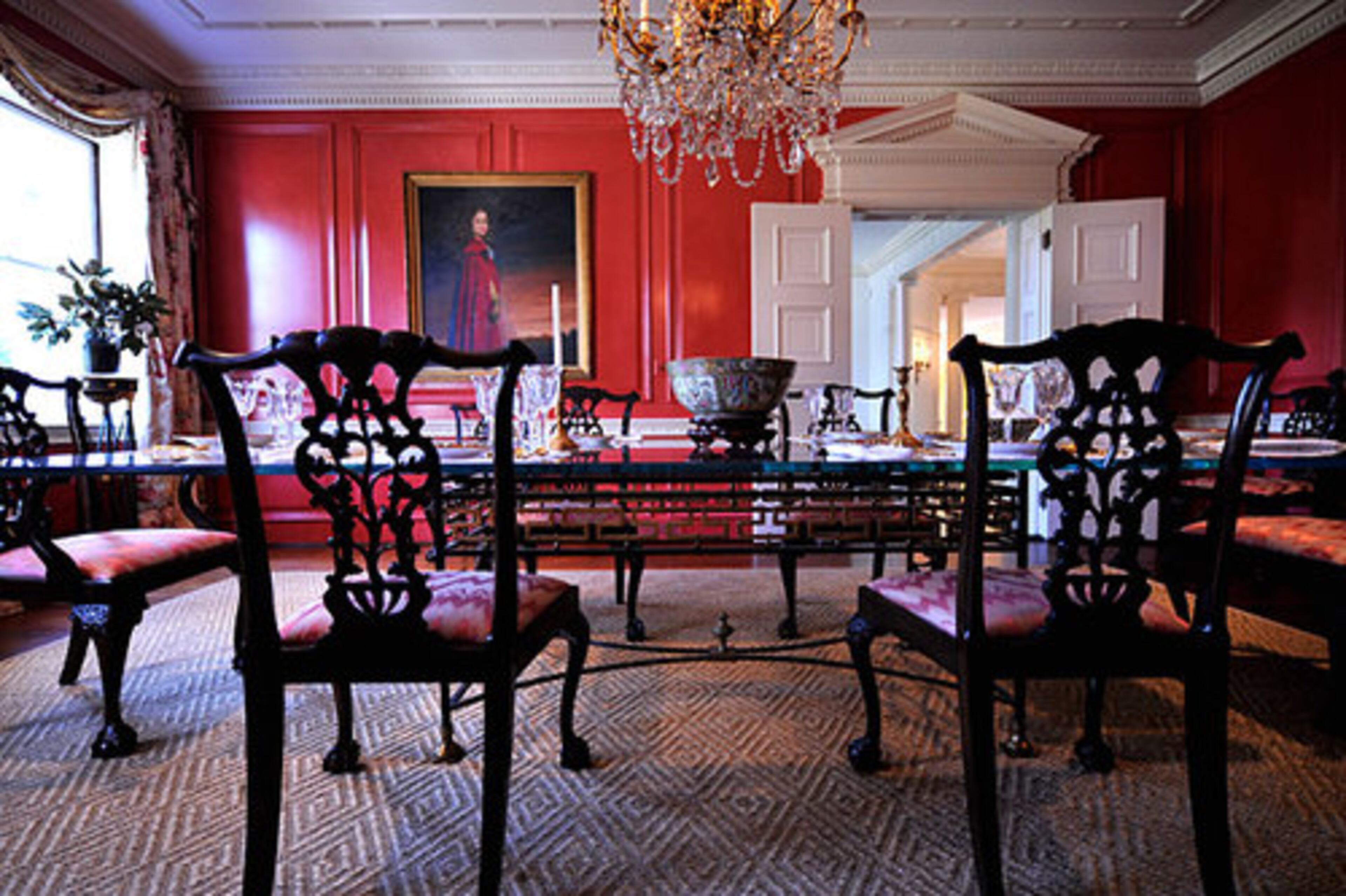 Inside Windcrofte, the dining room exudes grandeur. A painting of Ginny Millner as a youth in Mexico graces the far wall.